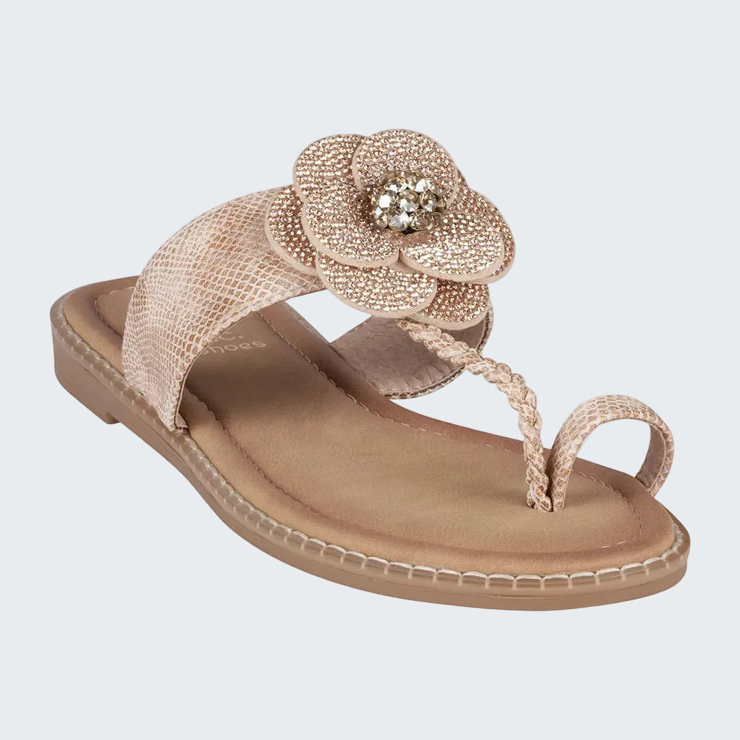 Beige sandal with a decorative flower on a white background