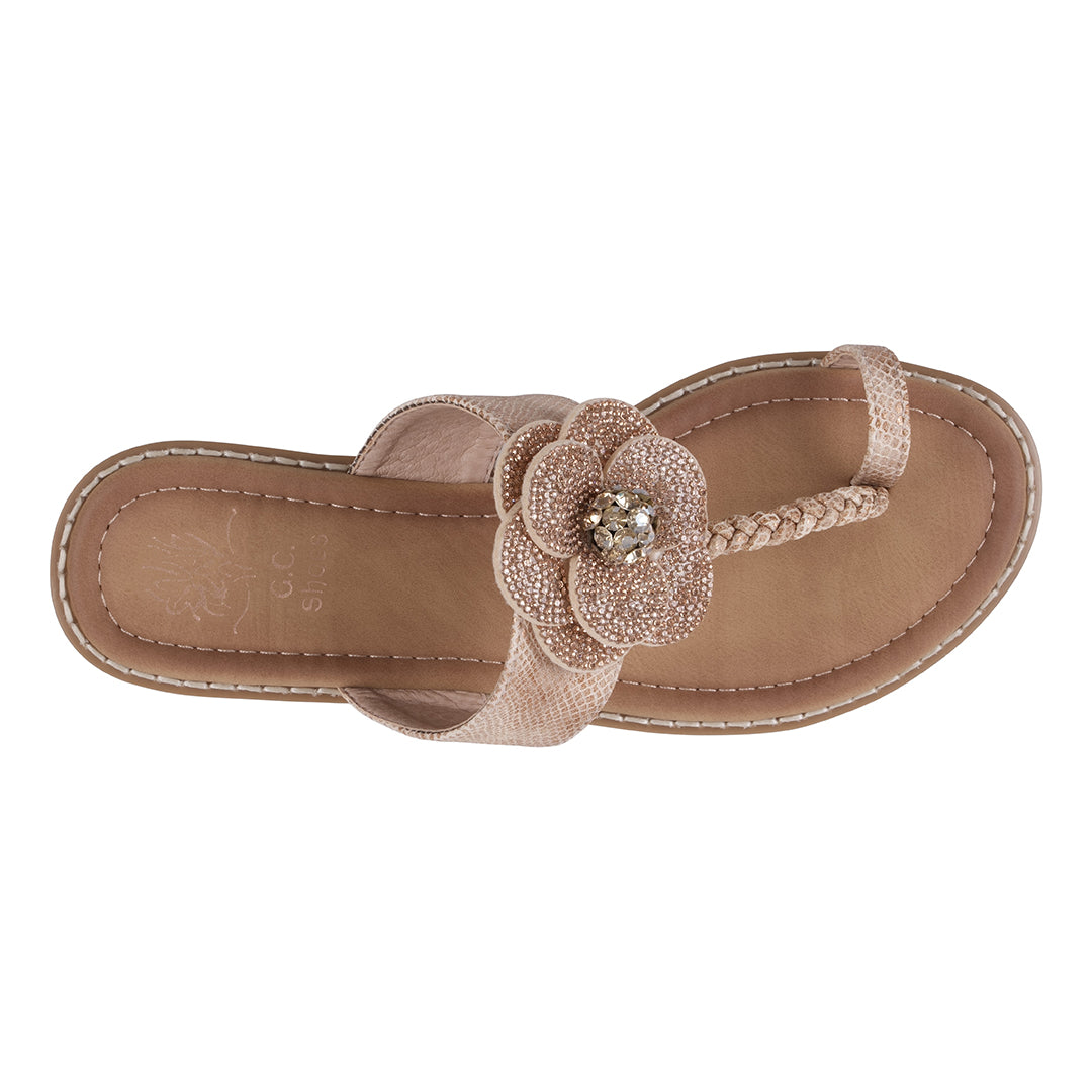Beige sandal with a decorative flower on a white background