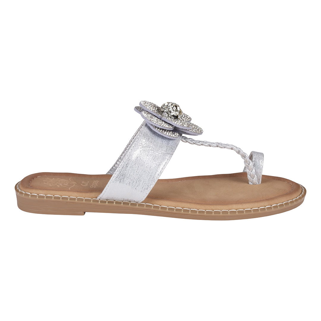 Silver sandal with decorative flower on a white background