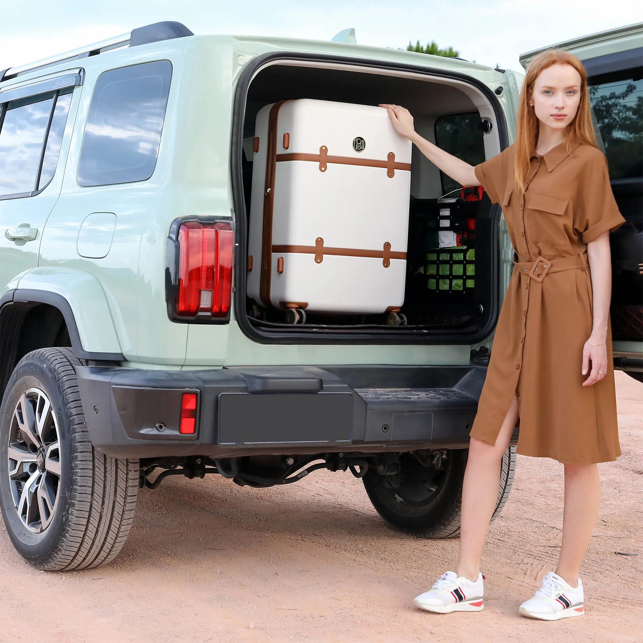 Woman opening the trunk of a light green SUV with a suitcase inside.