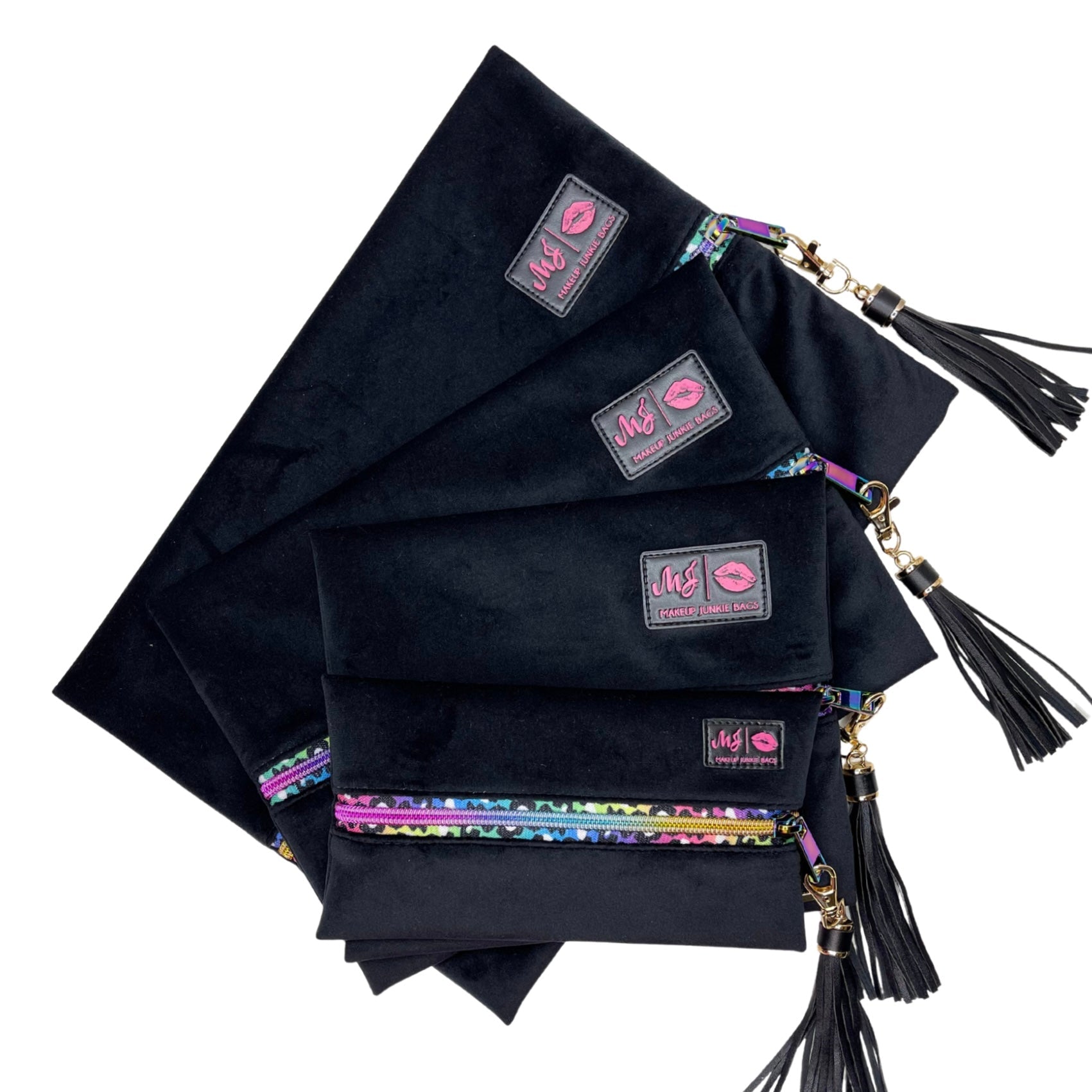 Set of black pouches with colorful accents and tassels on a white background