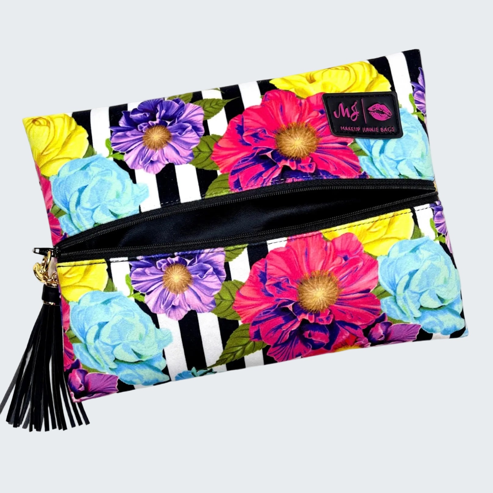 Makeup bag with colorful floral design and black and white striped pattern on a white background