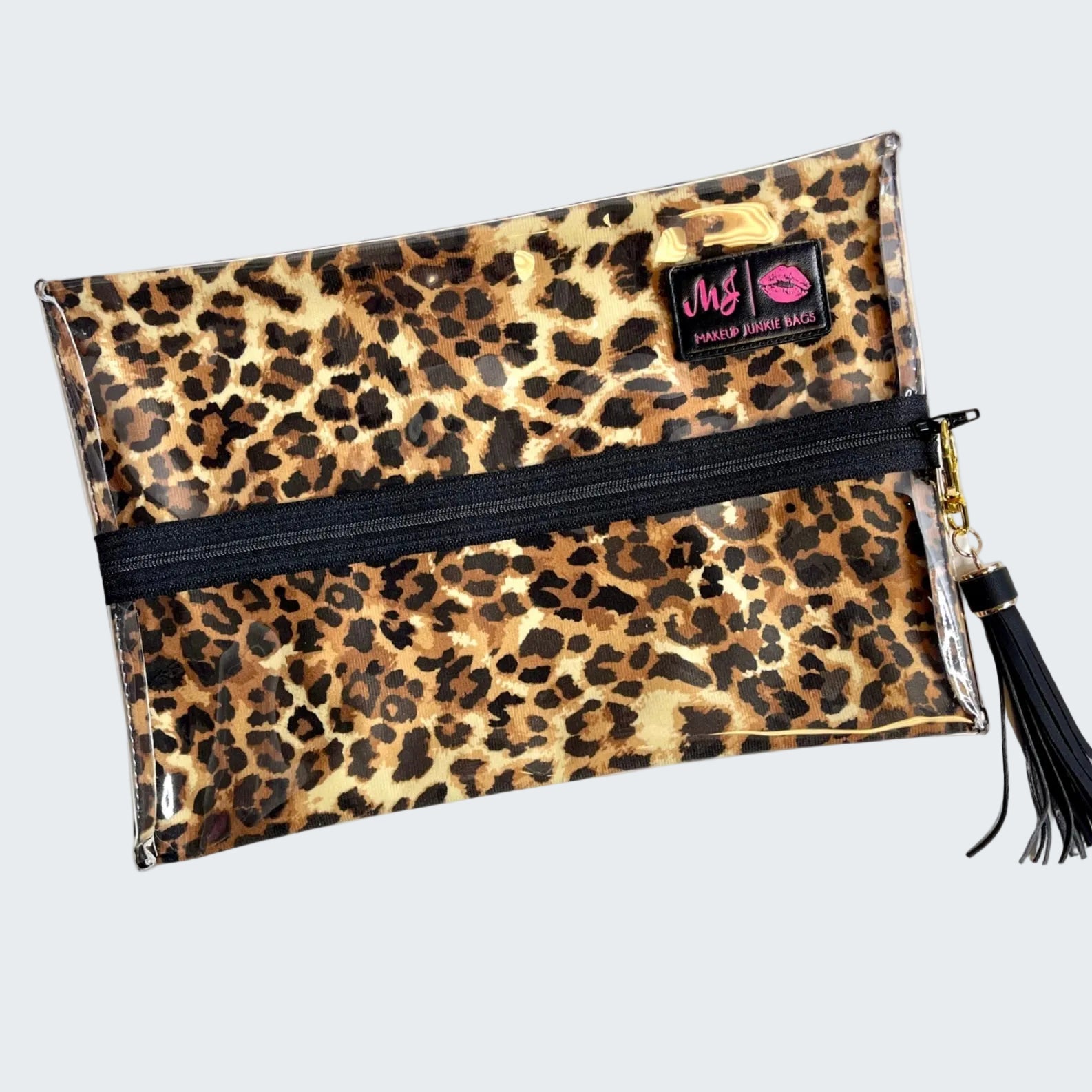 Leopard print clutch bag with a black zipper and tassel on a white background