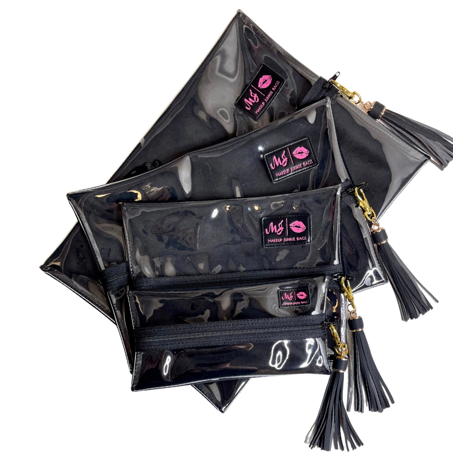 Stack of black makeup bags with visible brand logo on a white background