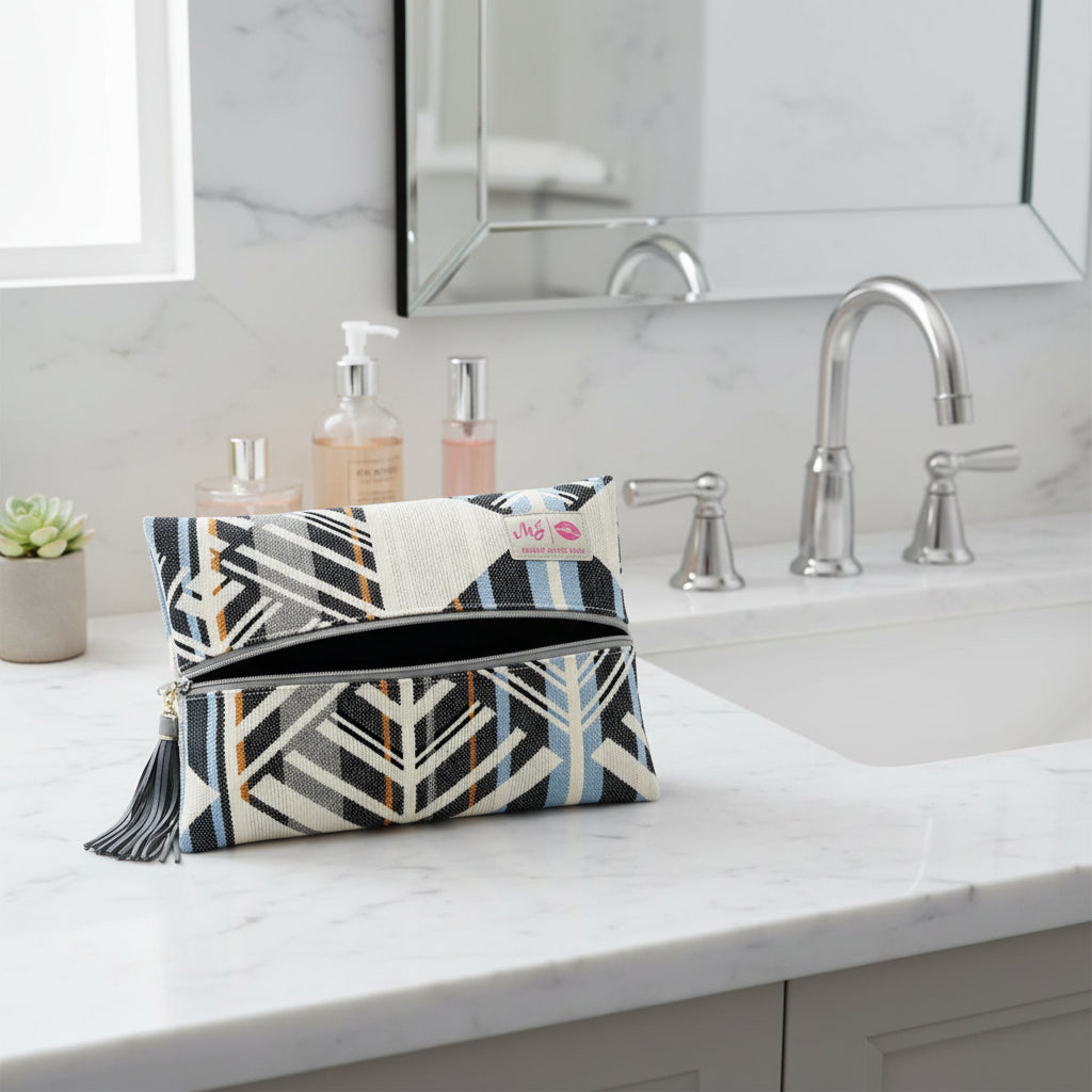Patterned clutch bag with a visible brand label on a light gray background