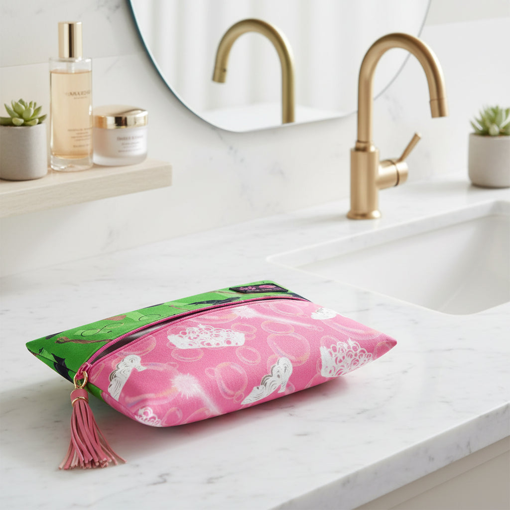 Makeup bag with green top and pink bottom featuring fairy designs on a white background