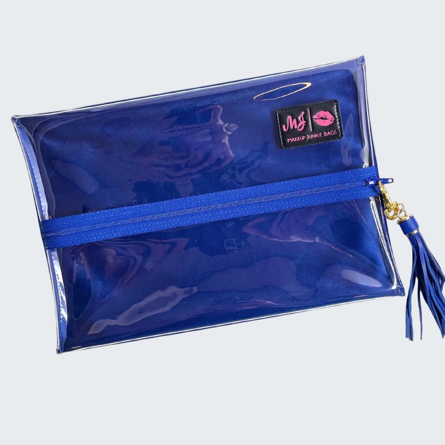 Blue makeup bag with a tassel on a white background