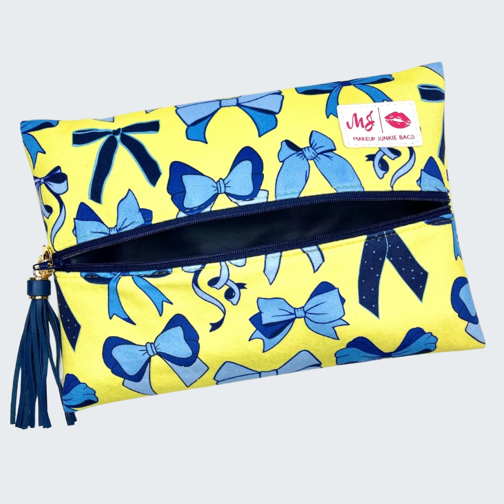 Yellow pouch with blue bow pattern and tassel on a white background