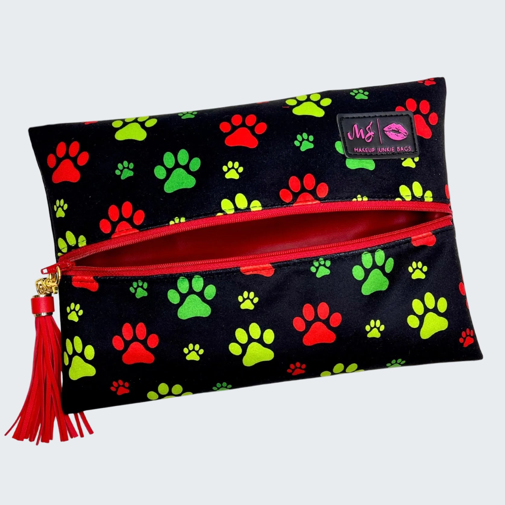 Makeup bag with colorful paw prints and a red zipper on a white background