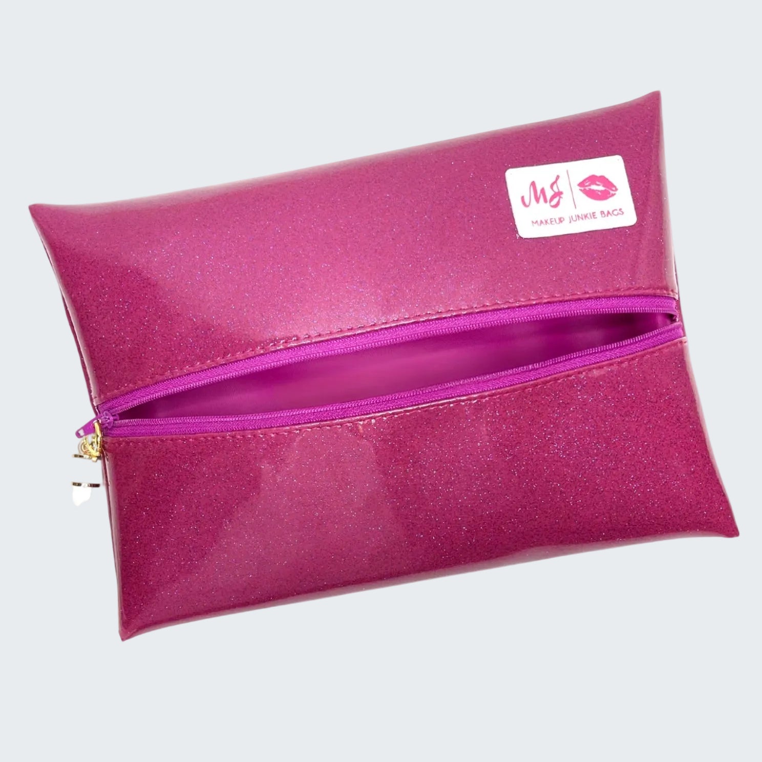 Pink makeup bag with a visible brand label on a white background