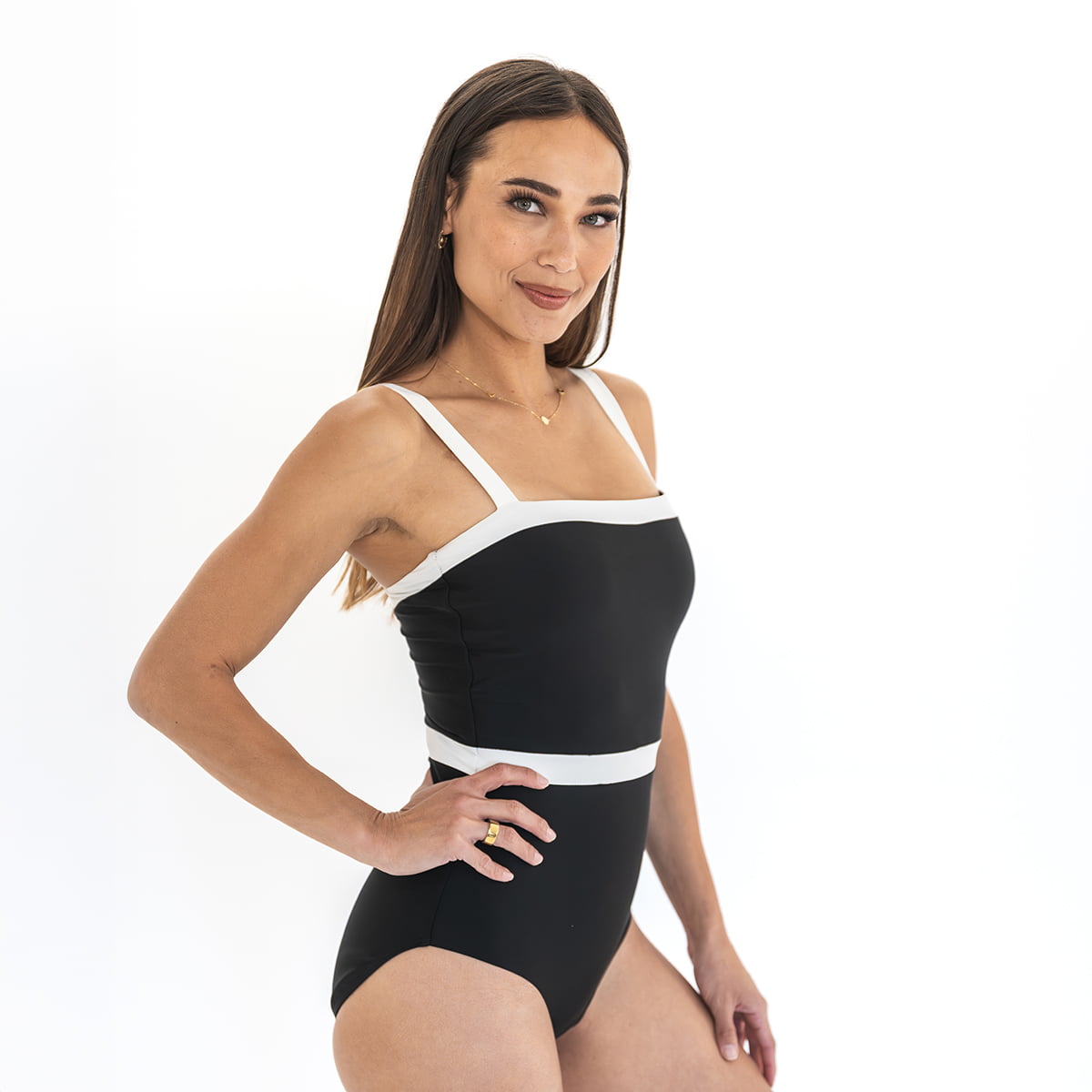 Woman wearing a black and white swimsuit on a white background