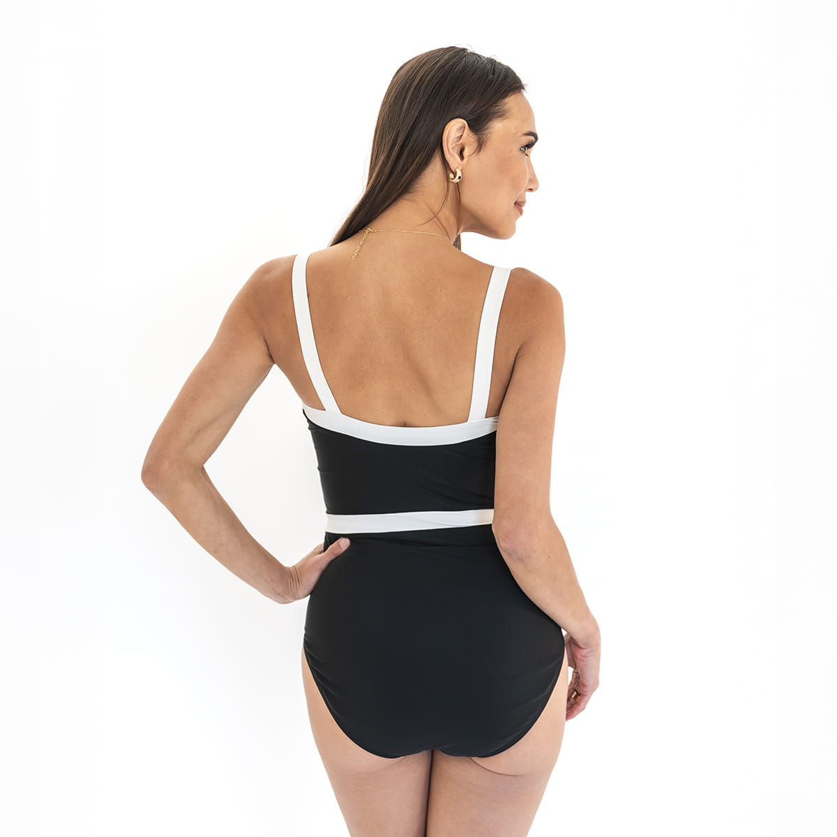 Woman wearing a black and white swimsuit on a white background