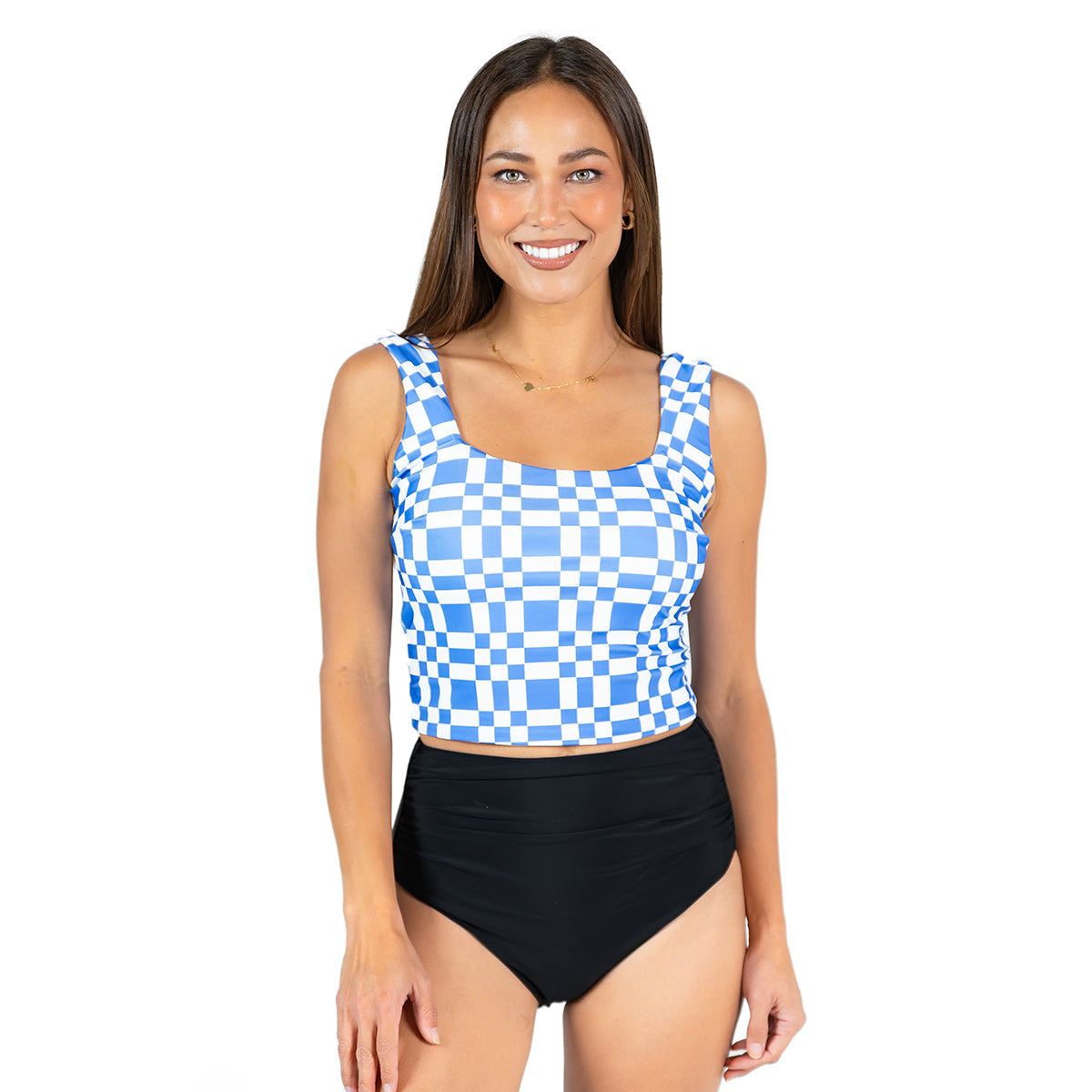 Woman wearing a blue and white checkered tank top with black high-waisted bottoms on a white background