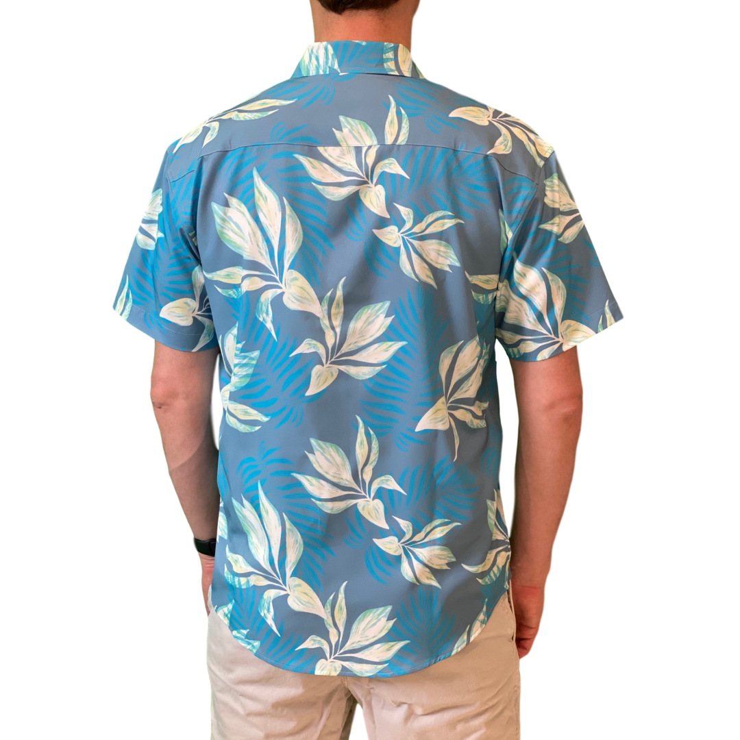 Person wearing a blue floral patterned shirt on a white background