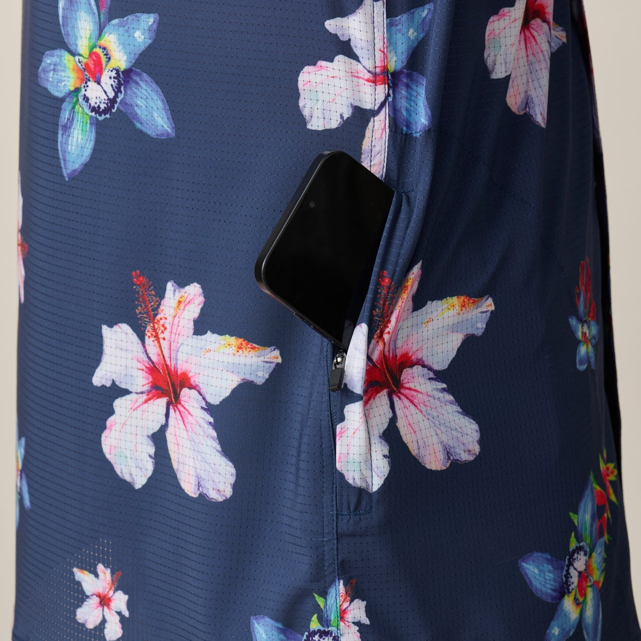 Navy blue shirt with colorful floral patterns on a beige background