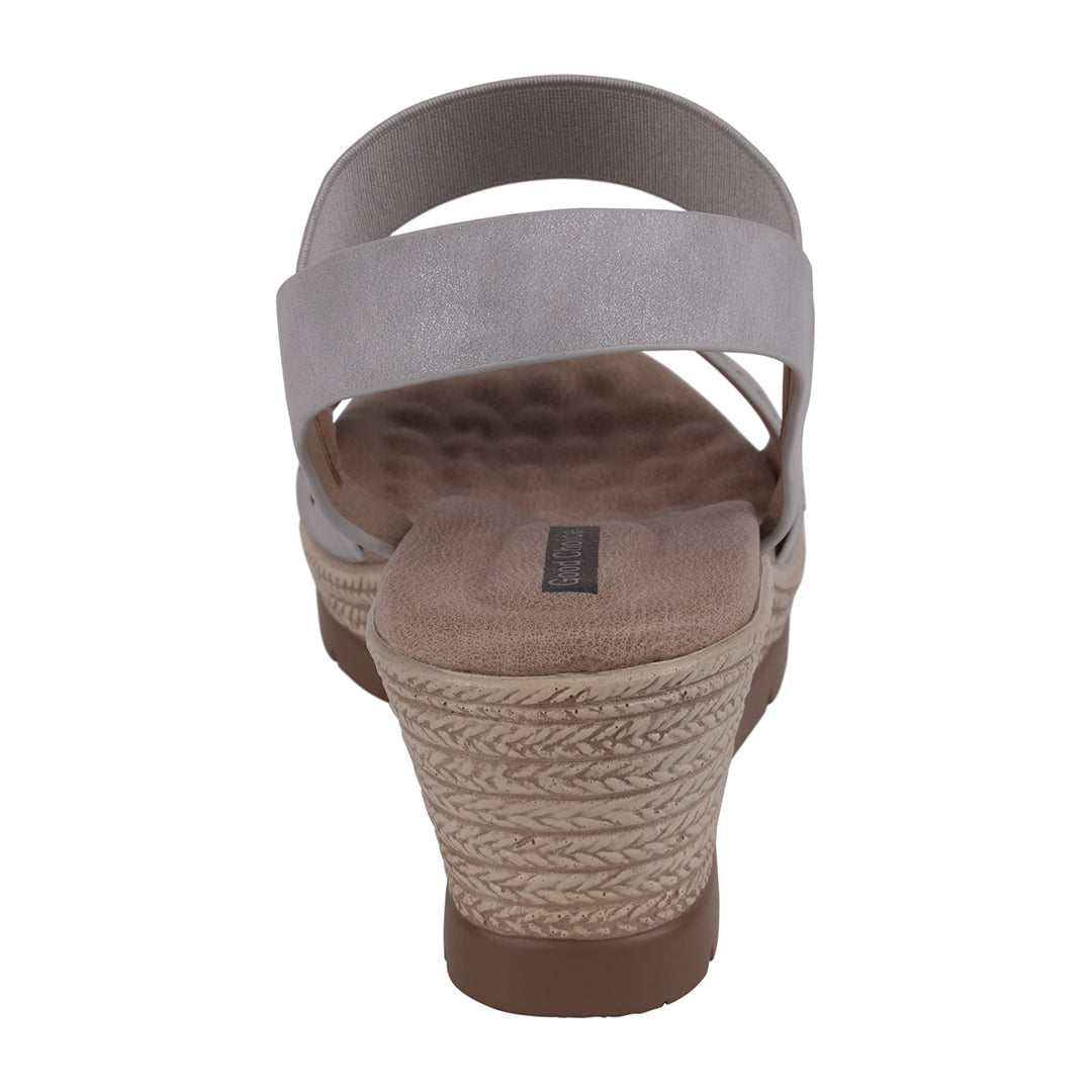 Wedge sandal with textured sole and gray strap on a white background