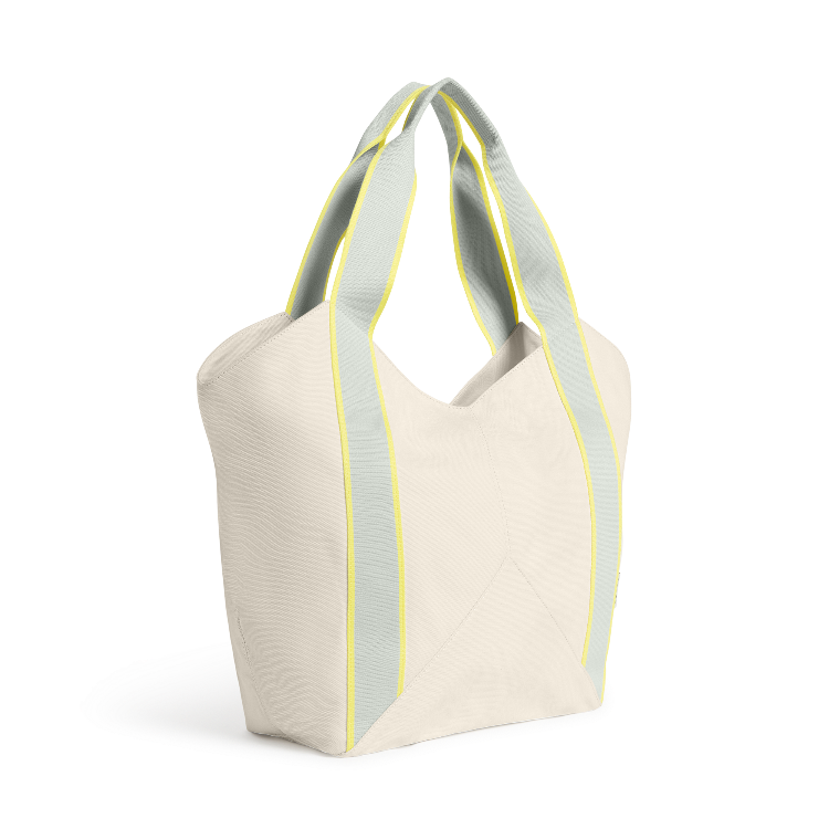 Beige tote bag with green straps on a white background