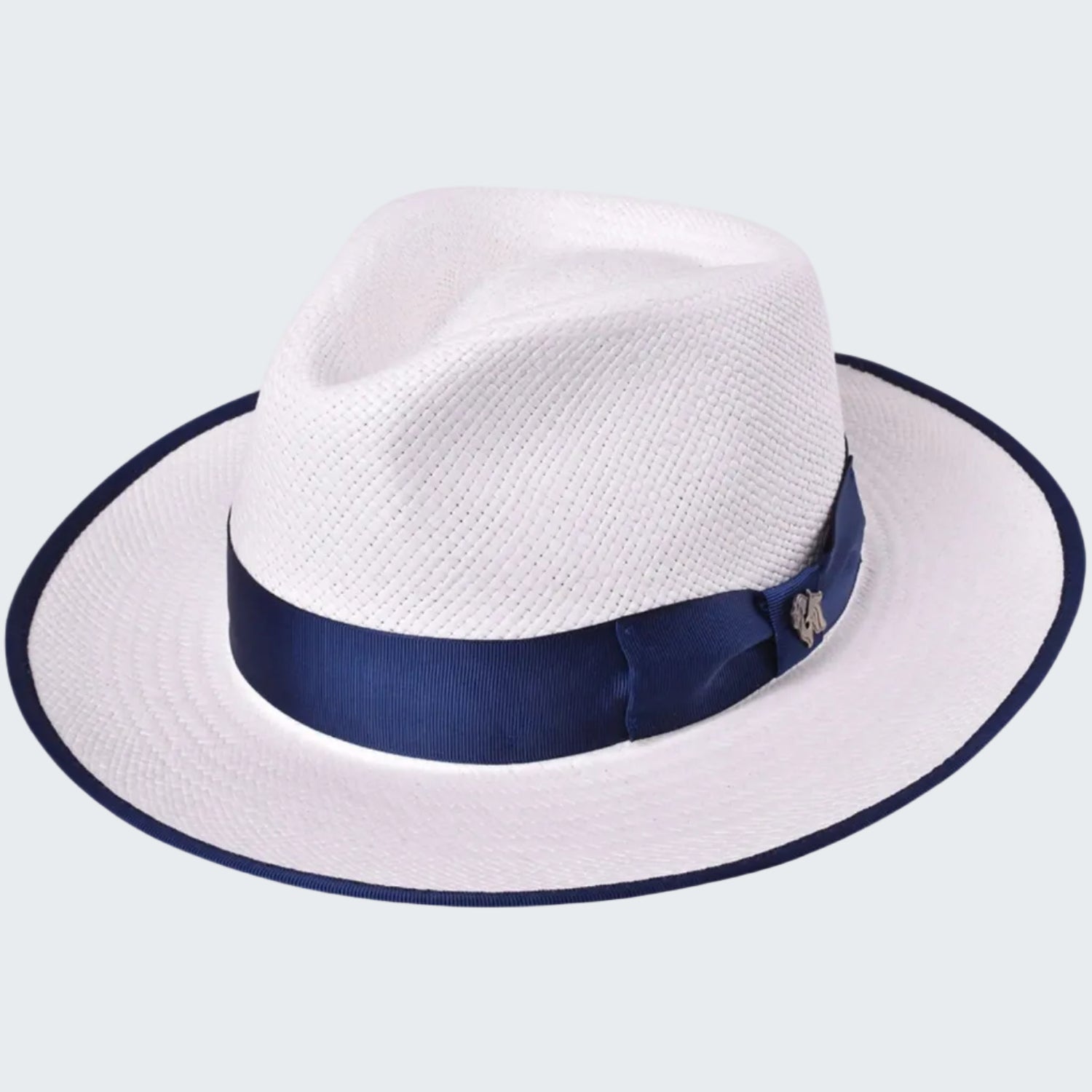 White straw hat with a navy blue band on a white background