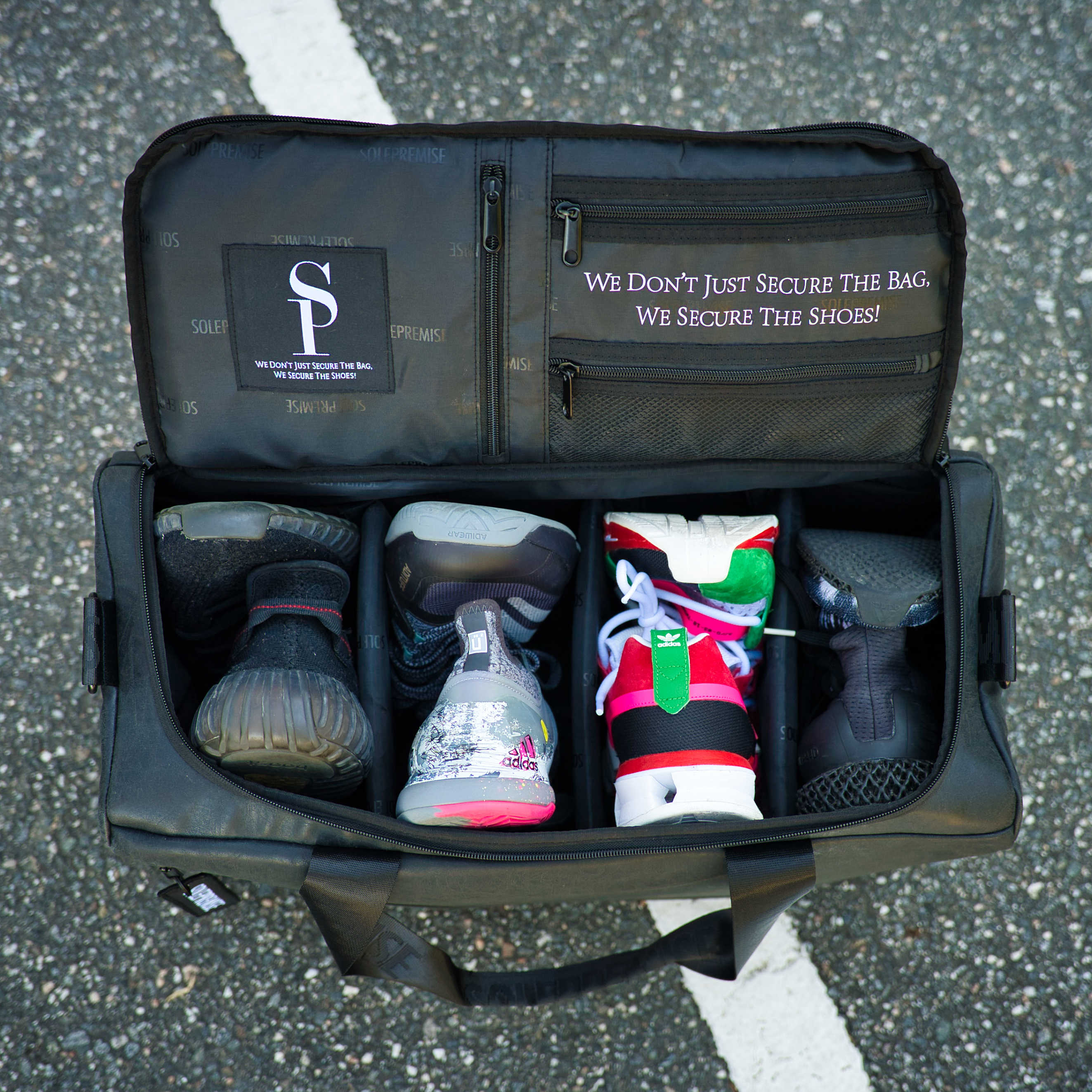 Black shoe bag with shoes inside on a concrete surface
