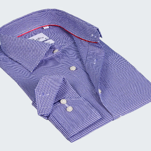 Folded blue checkered shirt with red interior on a white background