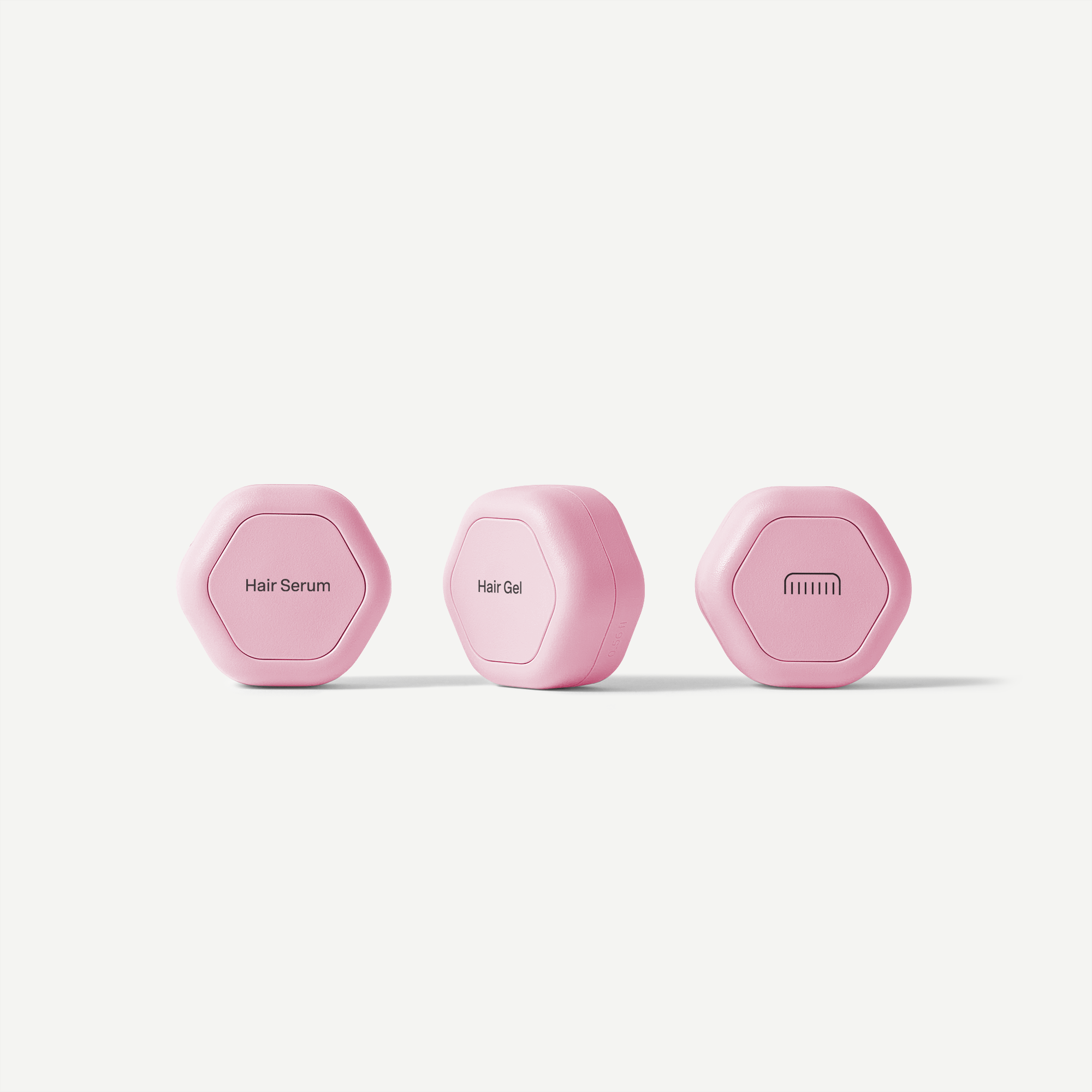 Three pink hair care products labeled 'Hair Serum', 'Hair Gel', and 'Lumin' on a white background.