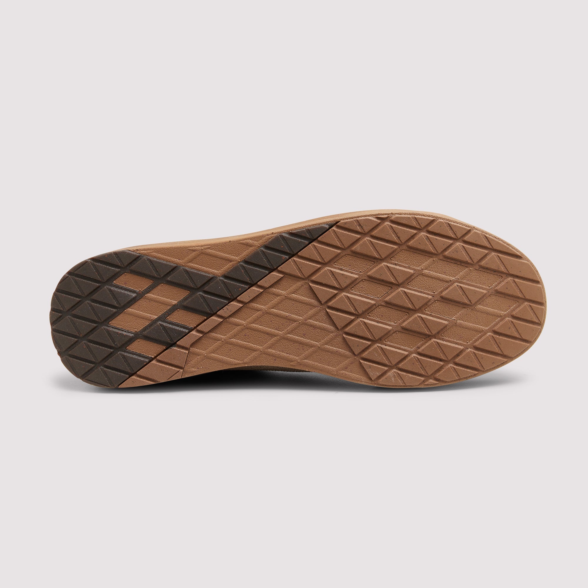 The outsole of a shoe shown from a top-down view, featuring a brown geometrically patterned tread with a darker brown diagonal accent on the heel, set against a light gray background.