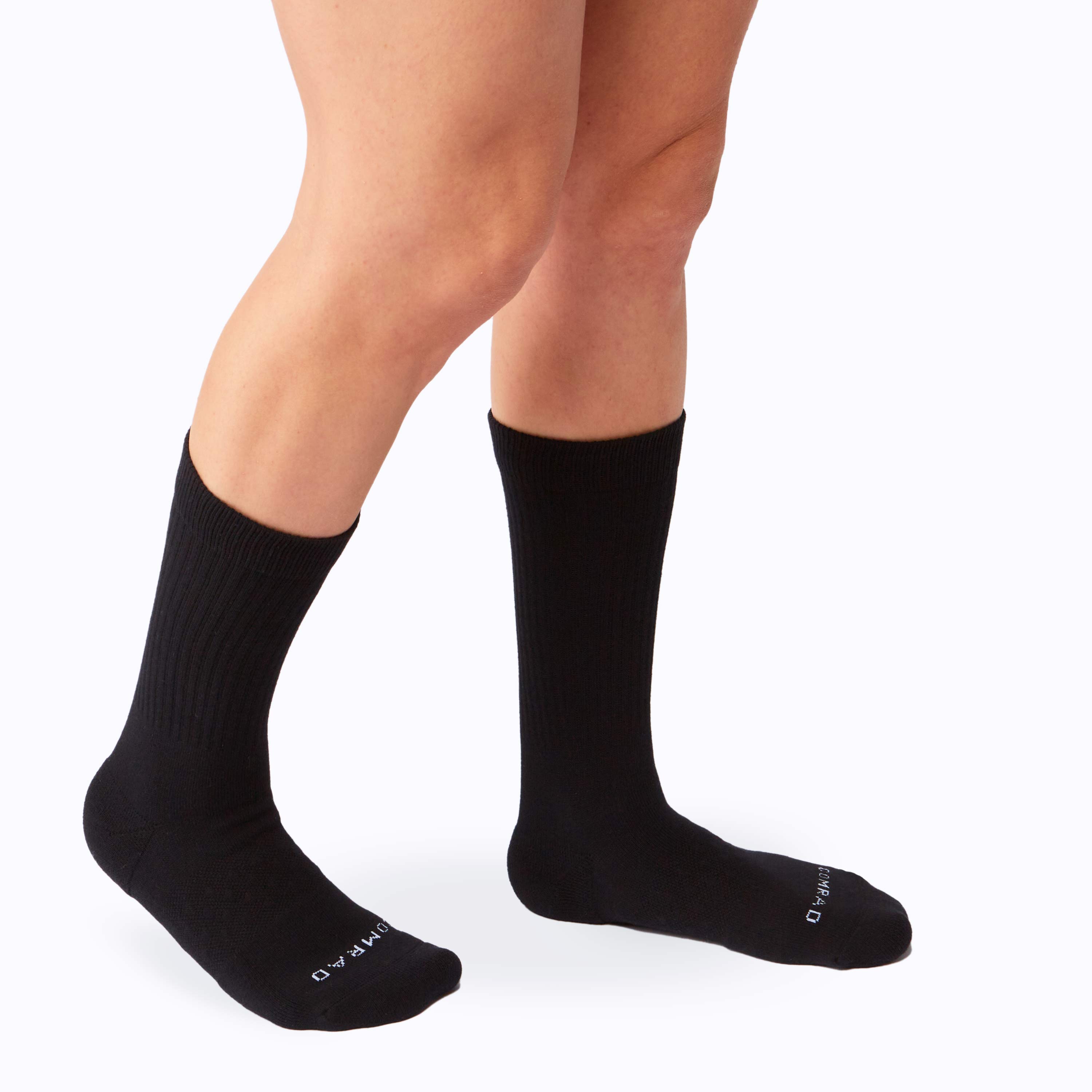 Black socks worn by a person on a white background