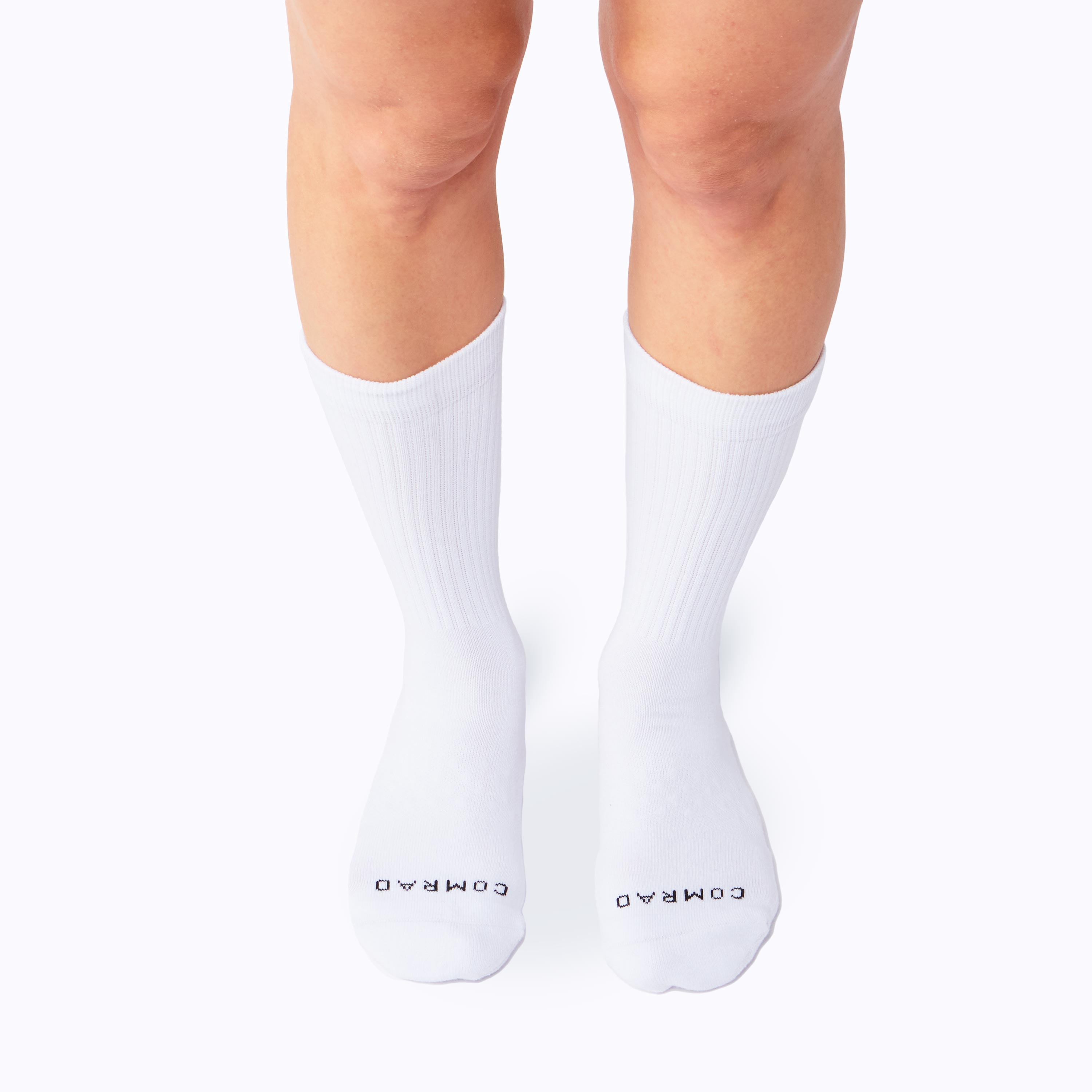 White socks with 'COMARDO' branding on a white background