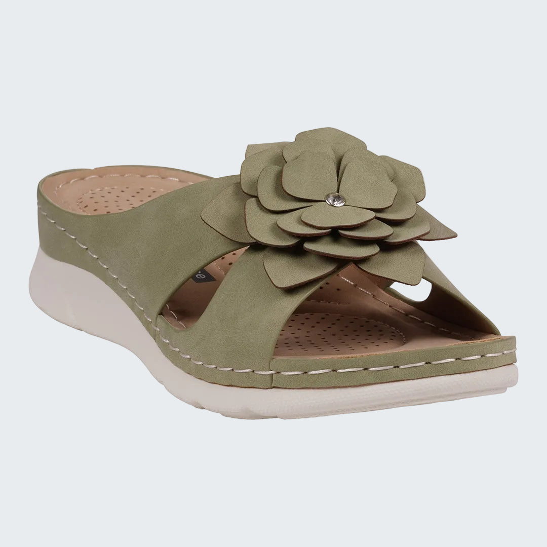 Green sandal with floral design on a white background