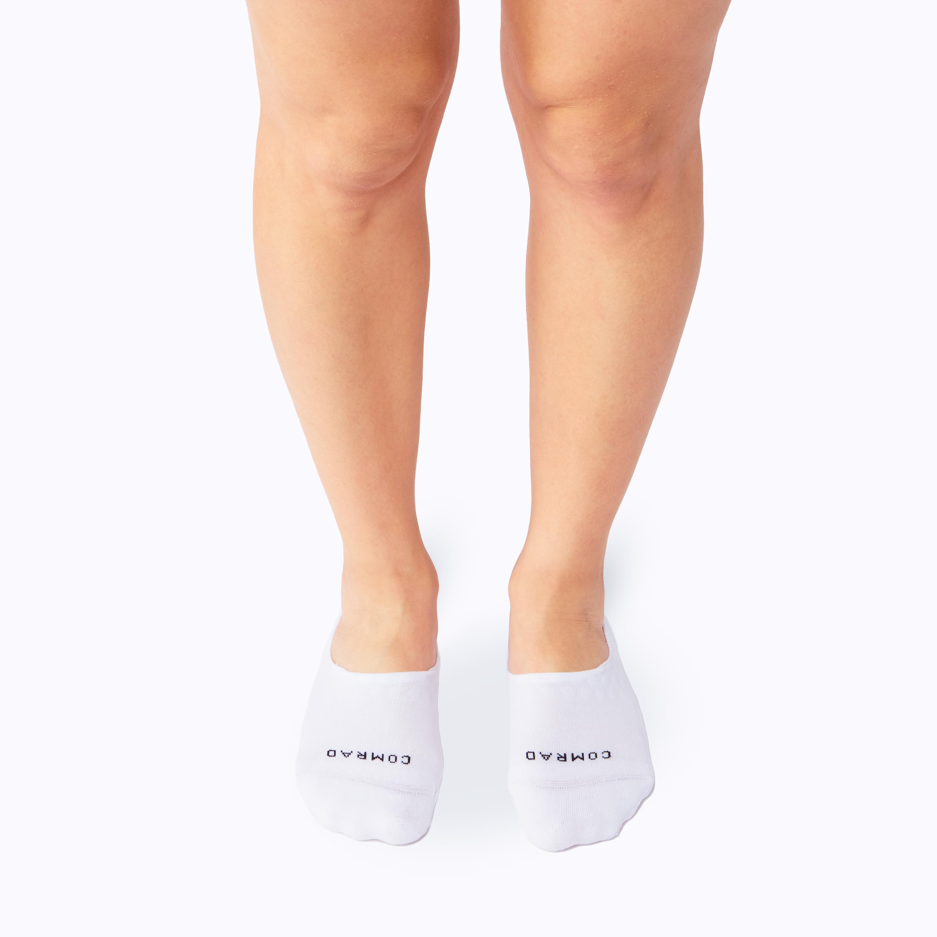 White ankle socks with a brand logo worn by a person on a white background