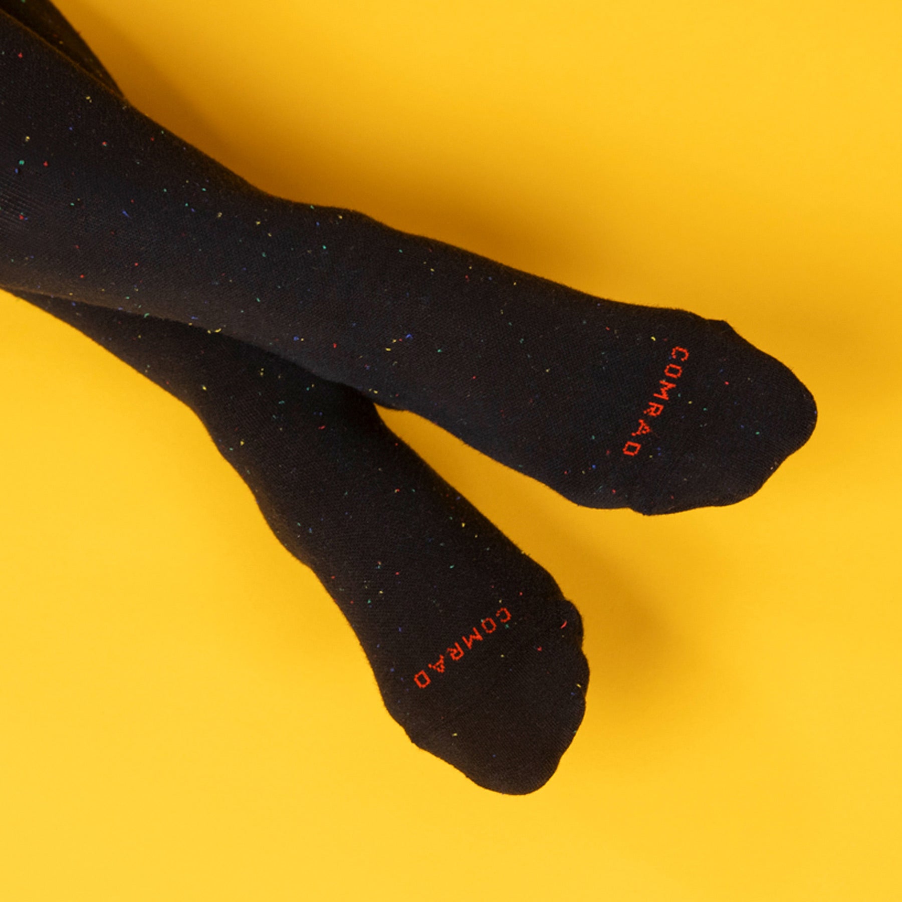 Black tights with 'GOMARO' branding on a yellow background