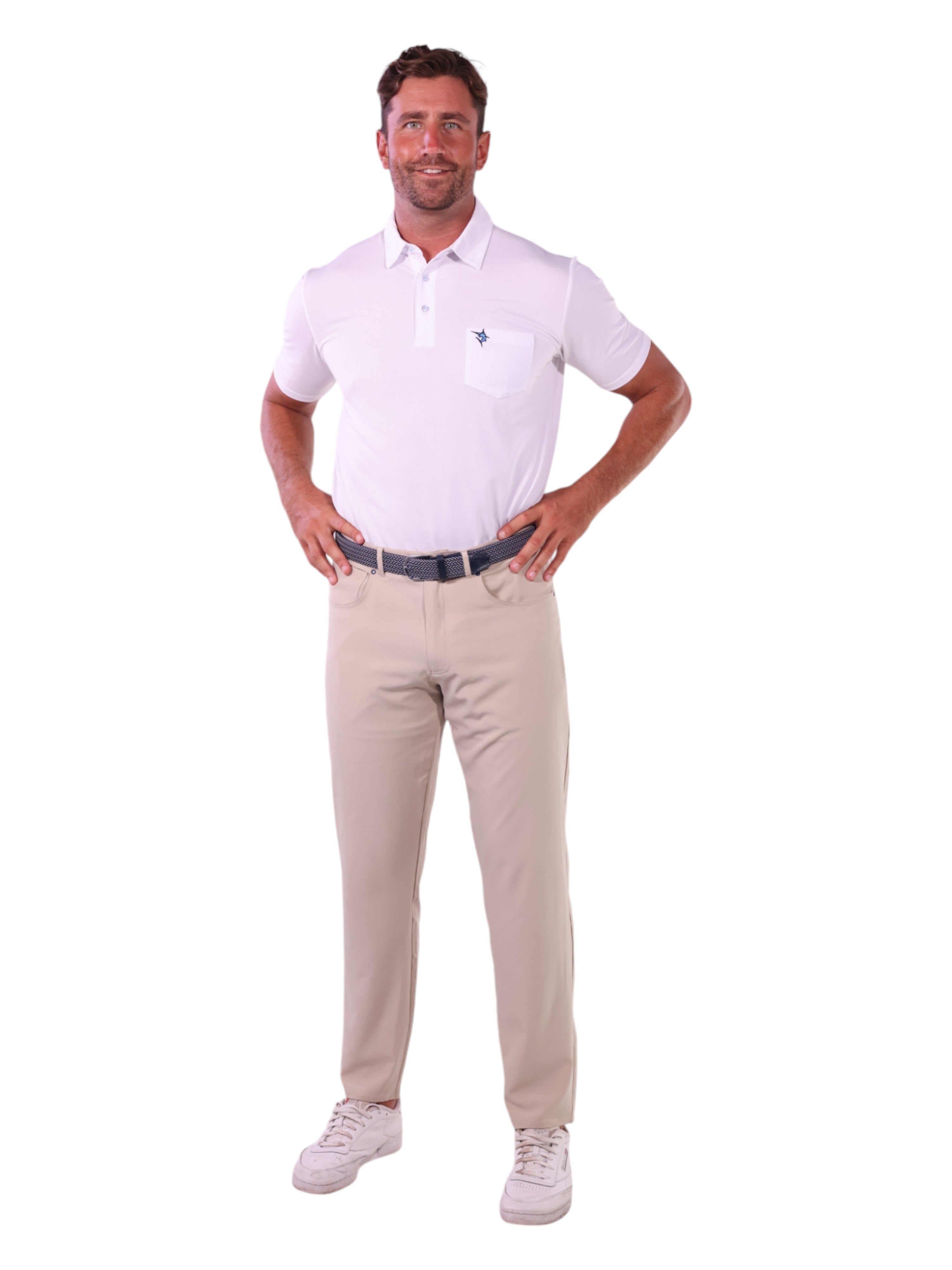 Man wearing a white polo shirt and beige pants on a white background