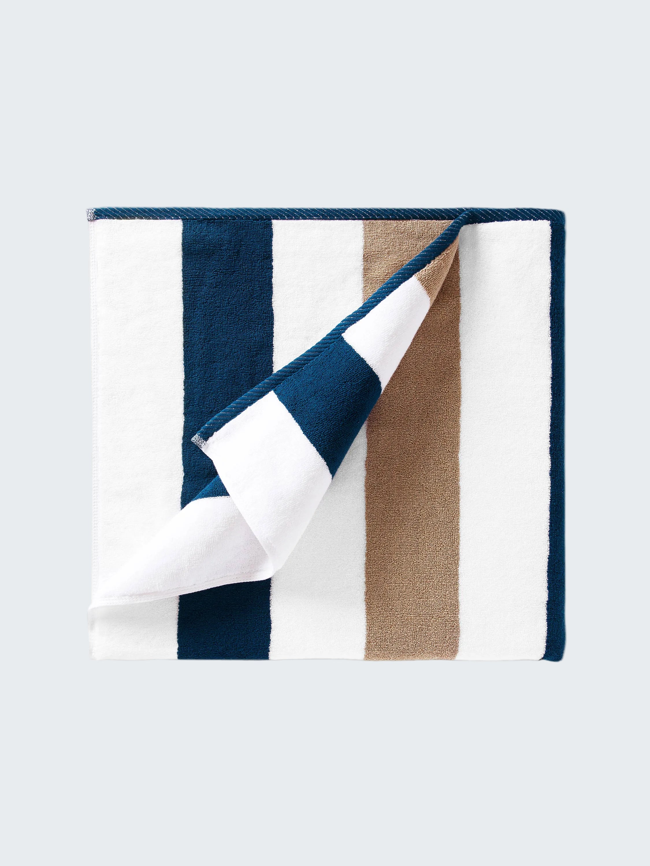 Folded fabric with blue, white, and brown stripes on a white background