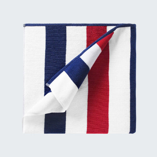 Folded towel with red, white, and blue stripes on a white background
