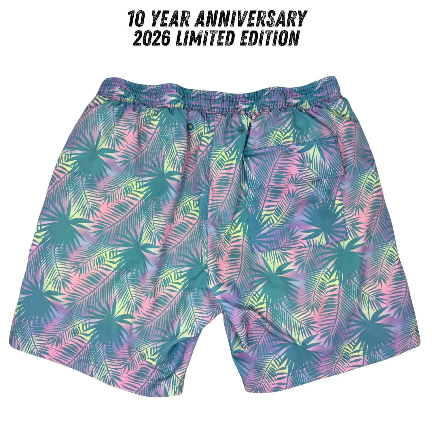 Colorful patterned shorts with tropical leaf design on a white background, featuring text for 10-year anniversary and limited edition.