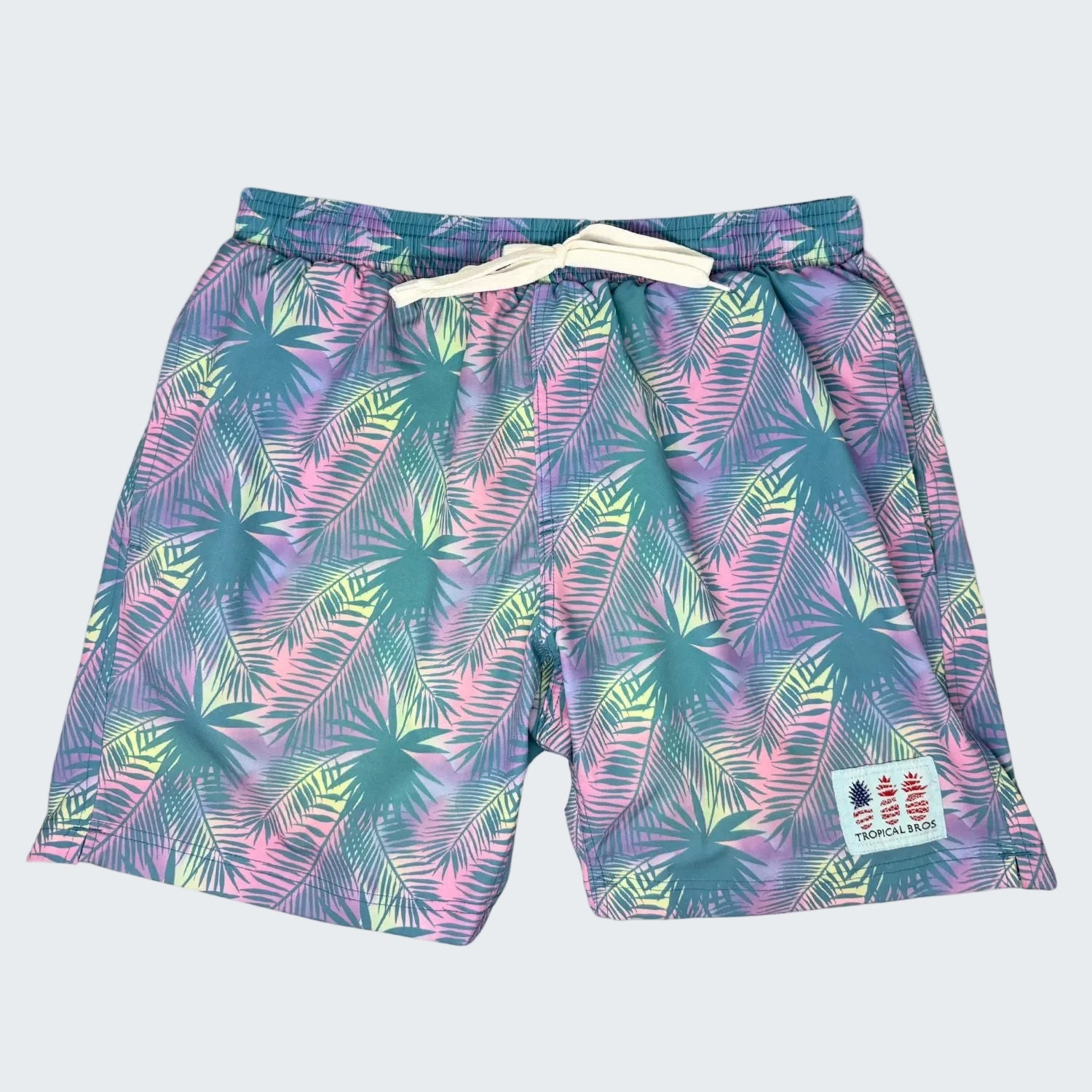 Tropical leaf patterned shorts with a brand logo on a white background, labeled as a 10-year anniversary 2026 limited edition product.