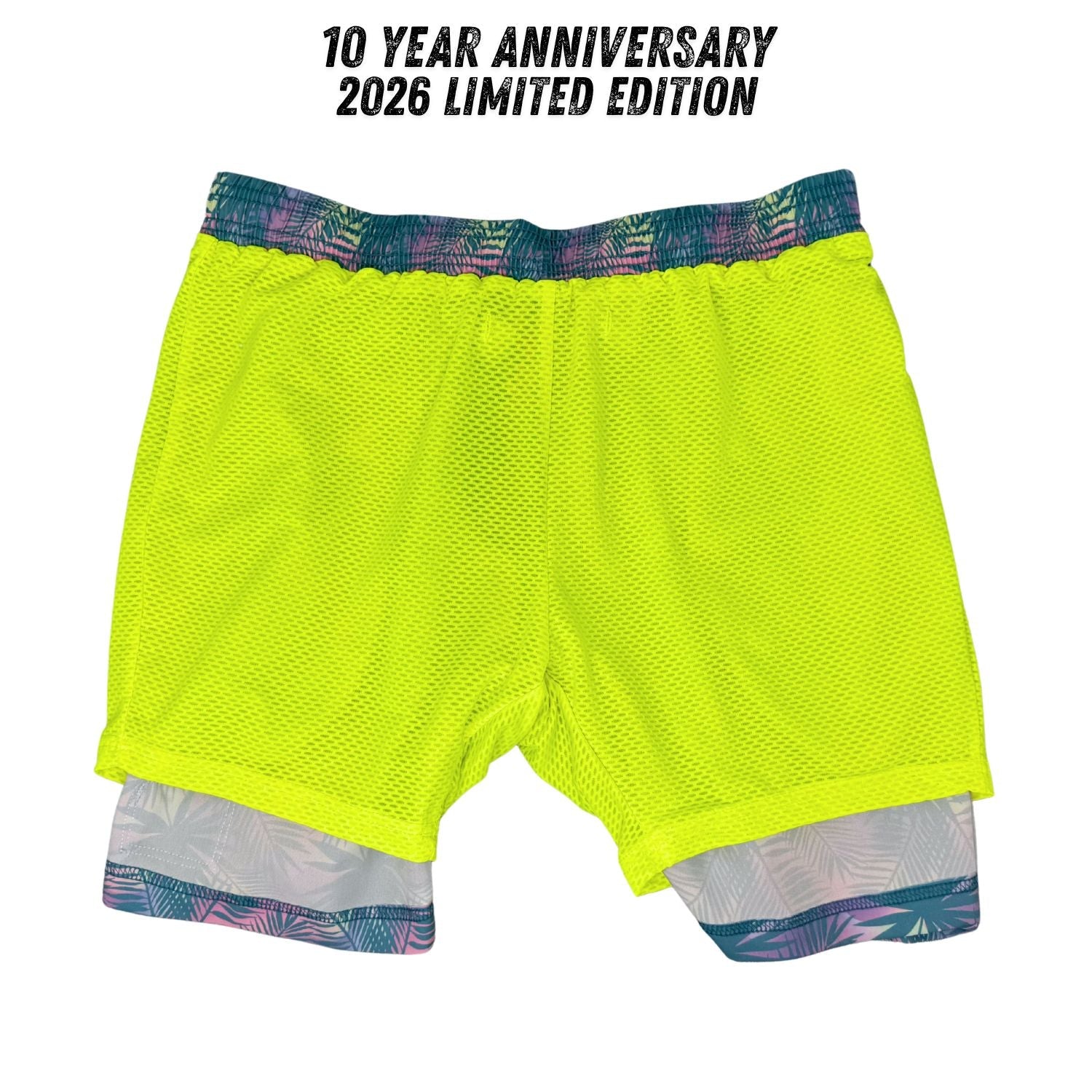 Neon yellow athletic shorts with a colorful waistband on a white background, labeled '10 Year Anniversary 2026 Limited Edition'.
