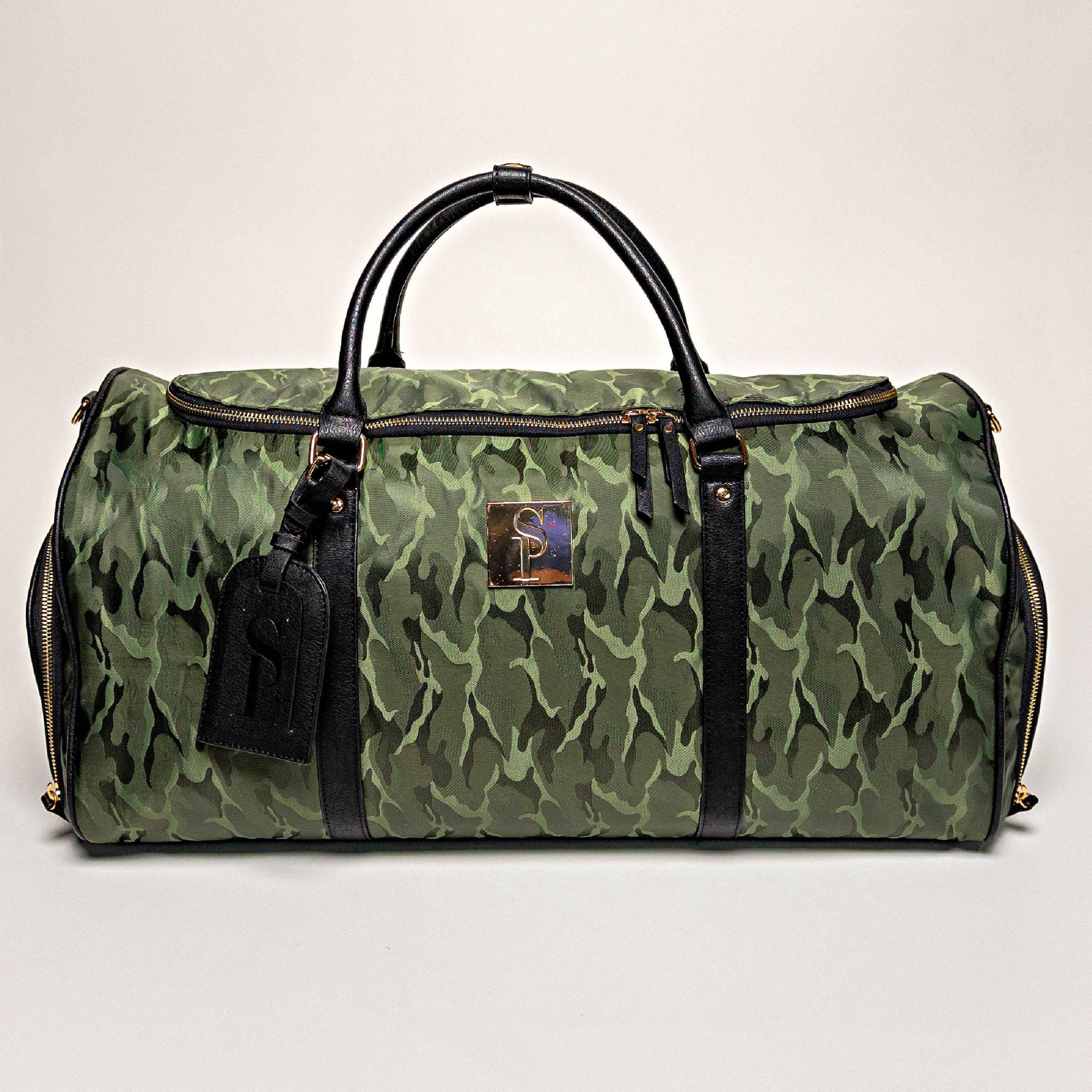 Green camouflage duffel bag with black handles and straps on a light gray background