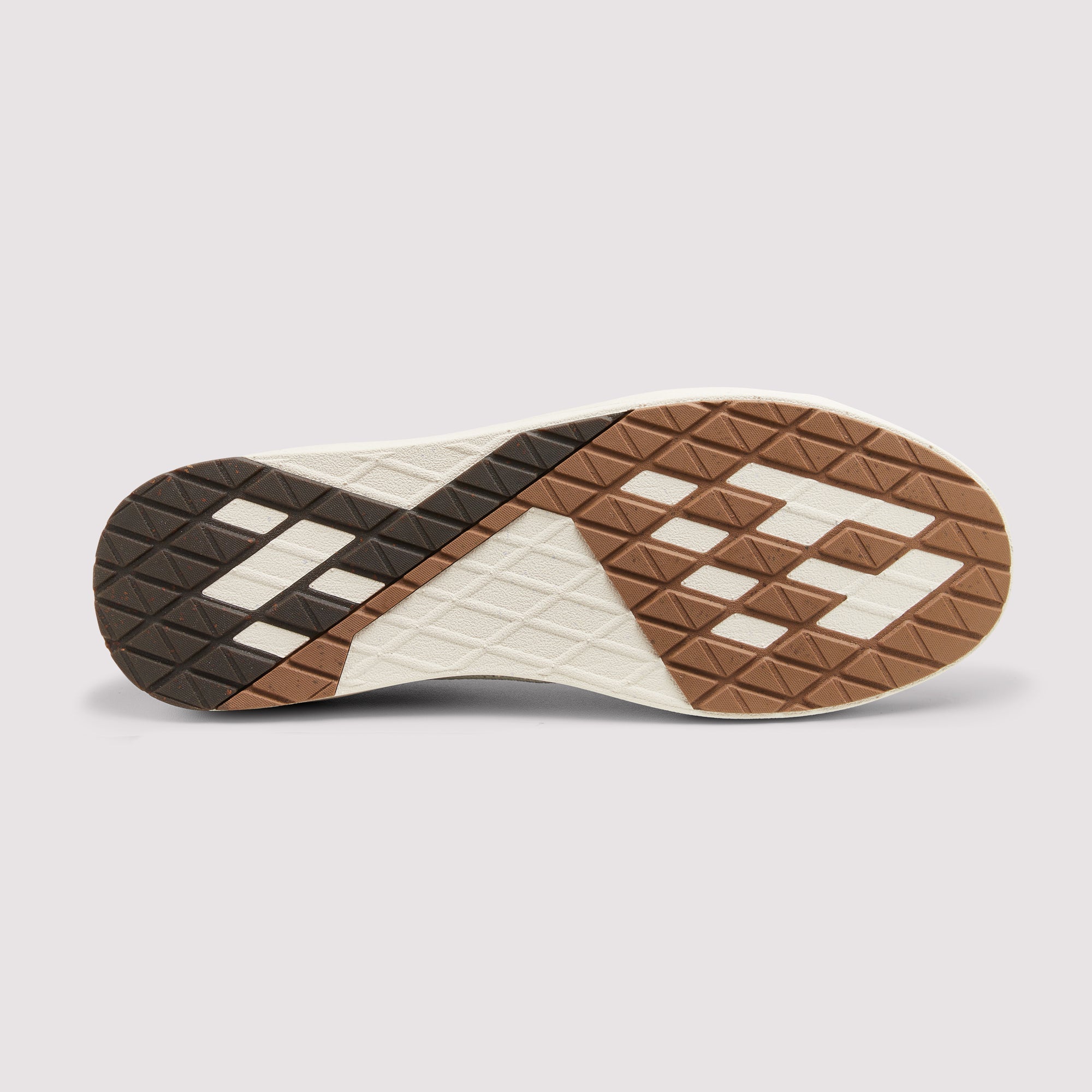 A close-up of a shoe sole showing a geometric tread pattern in brown, beige, and black on a light gray background.
