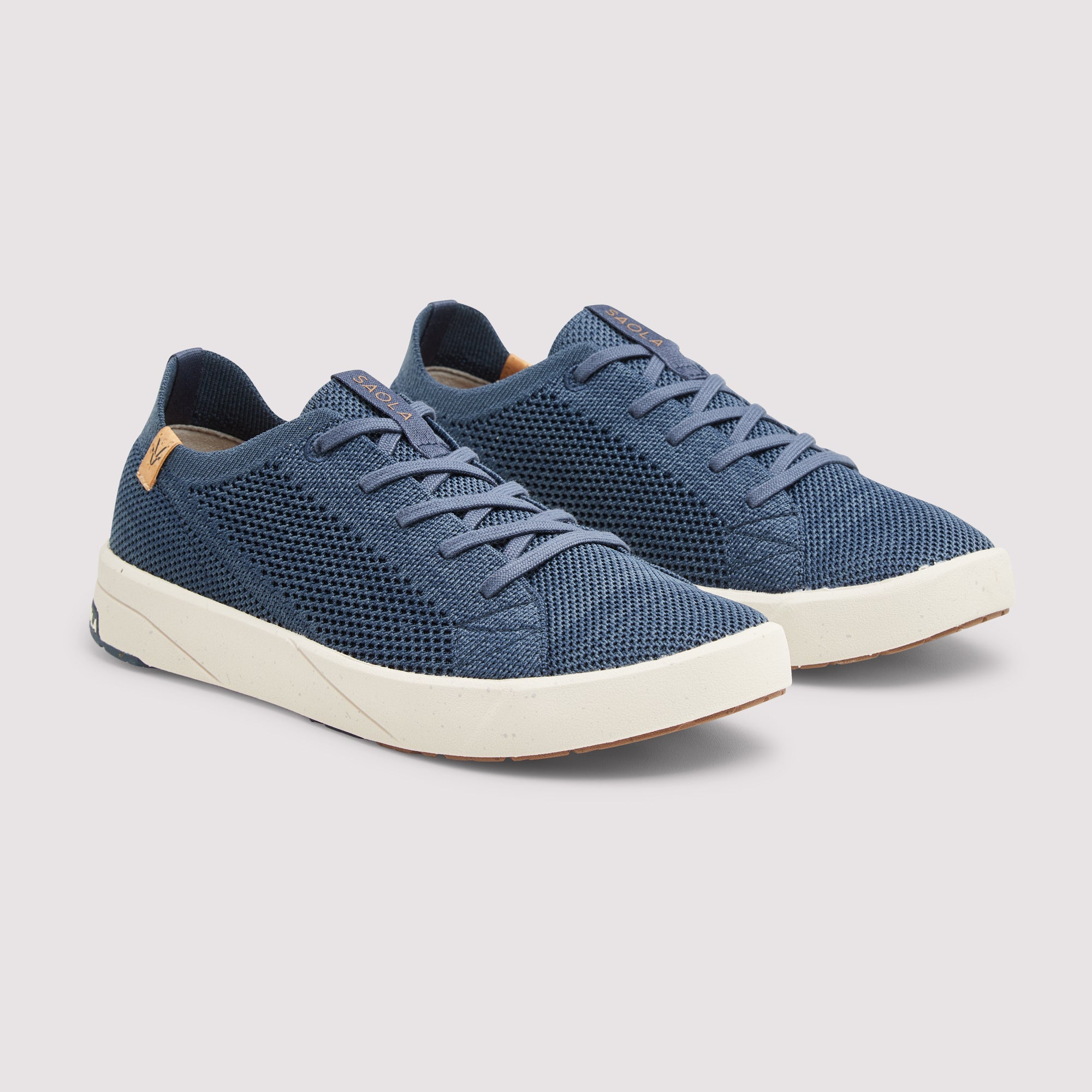 A pair of blue knit mesh low-top sneakers with white soles, displayed on a light gray background.