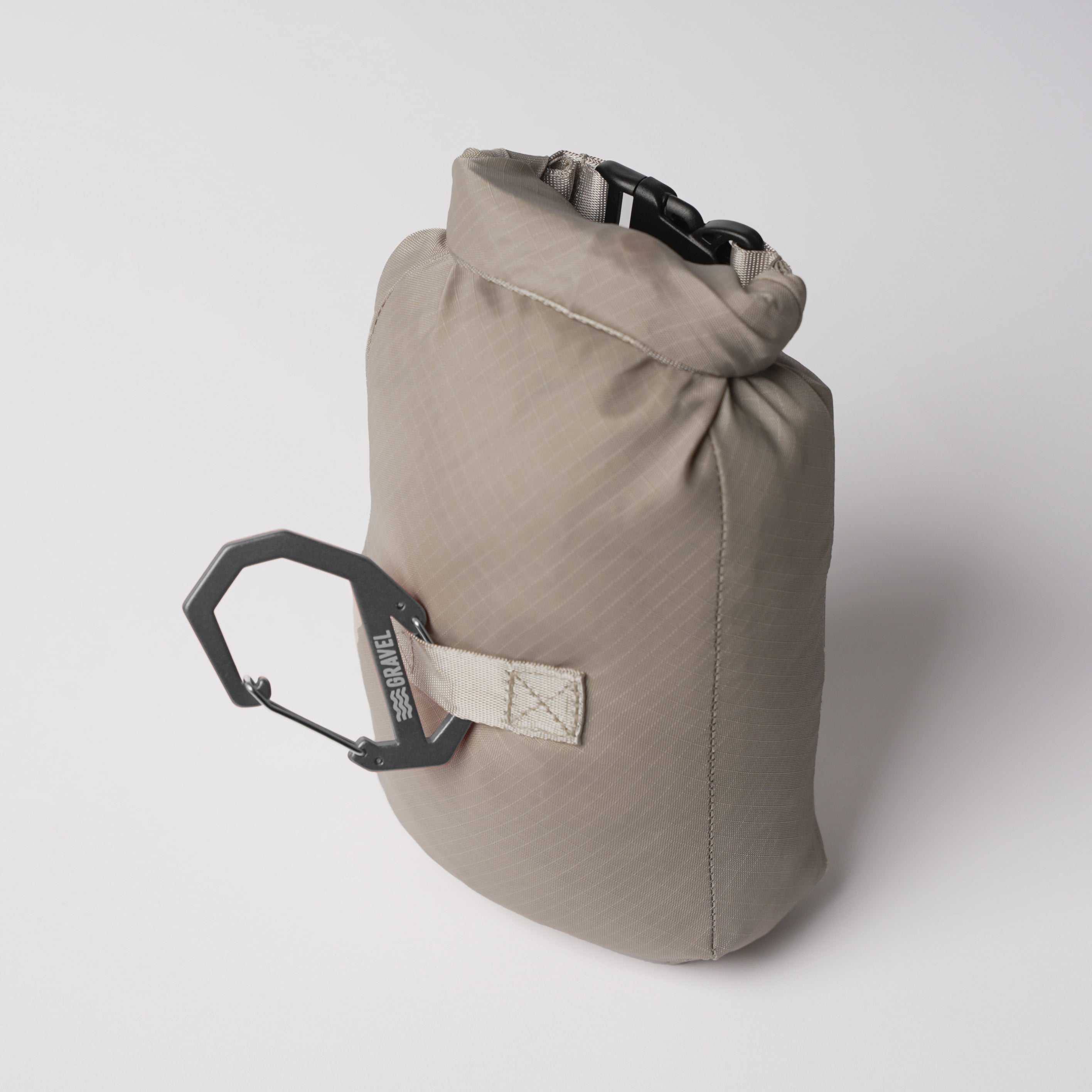 Beige dry bag with a carabiner on a white background