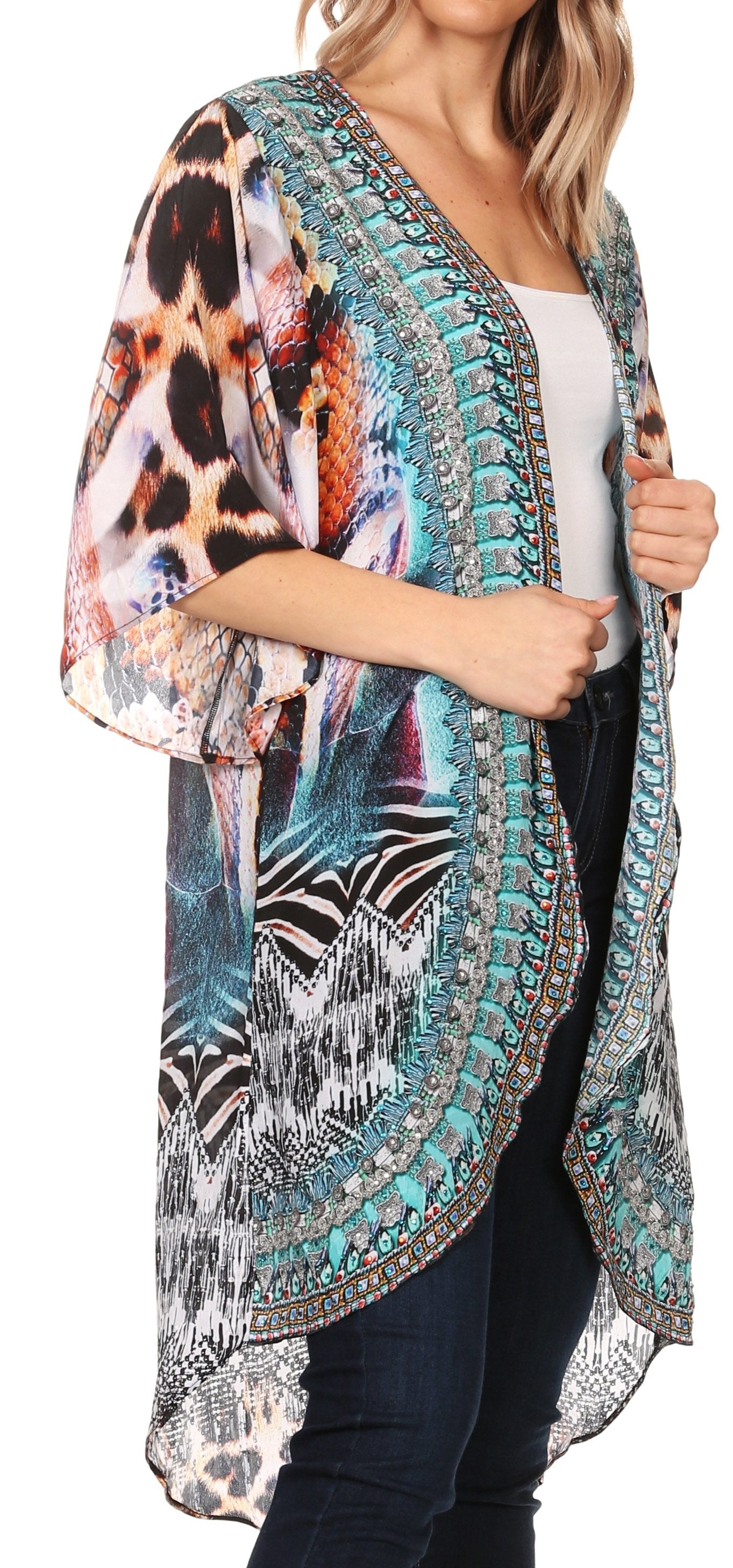 Woman wearing a colorful kimono-style cardigan with animal print patterns on a white background