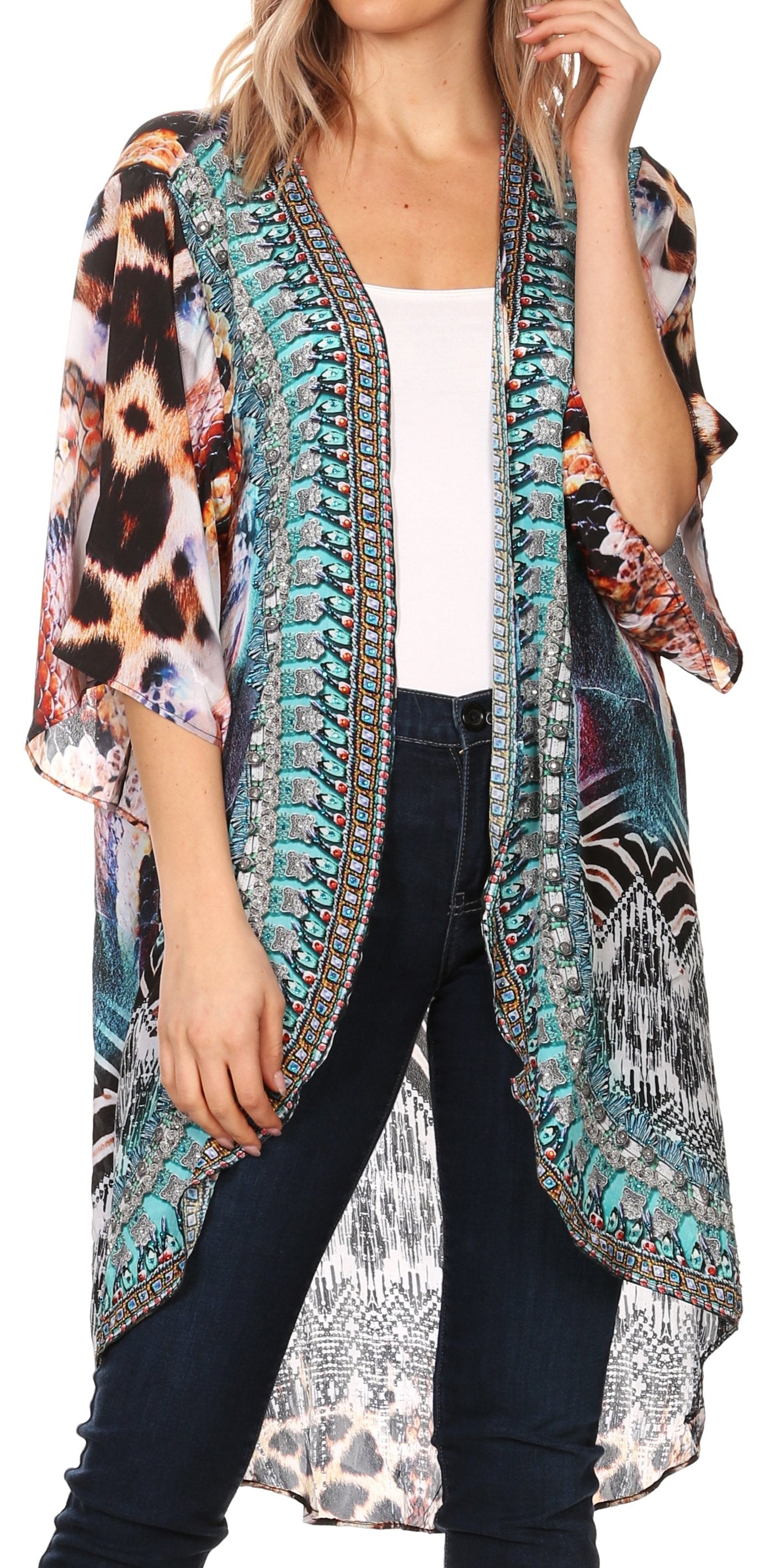 Woman wearing a colorful patterned kimono over a white top and dark jeans.