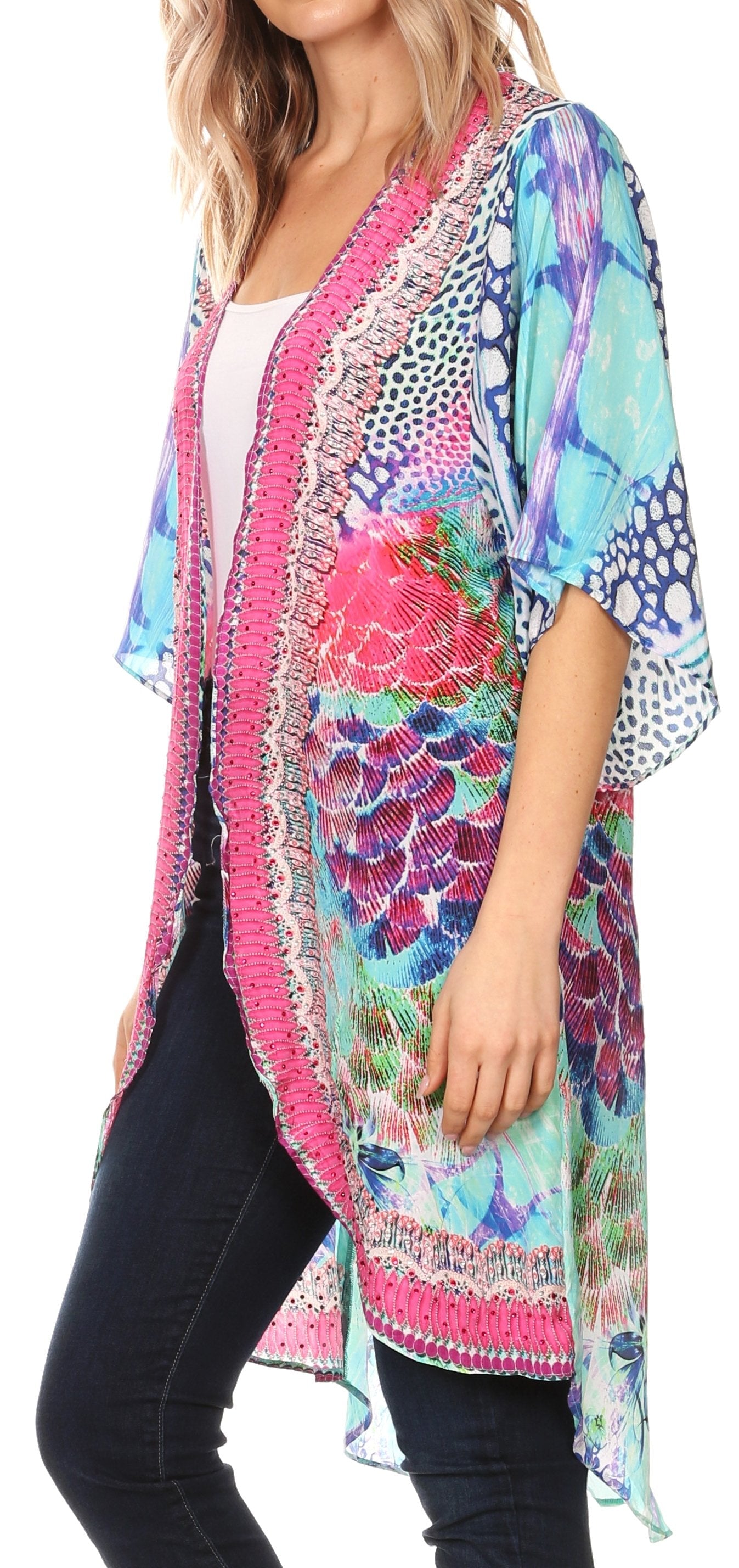 Woman wearing a colorful kimono-style jacket with floral patterns.