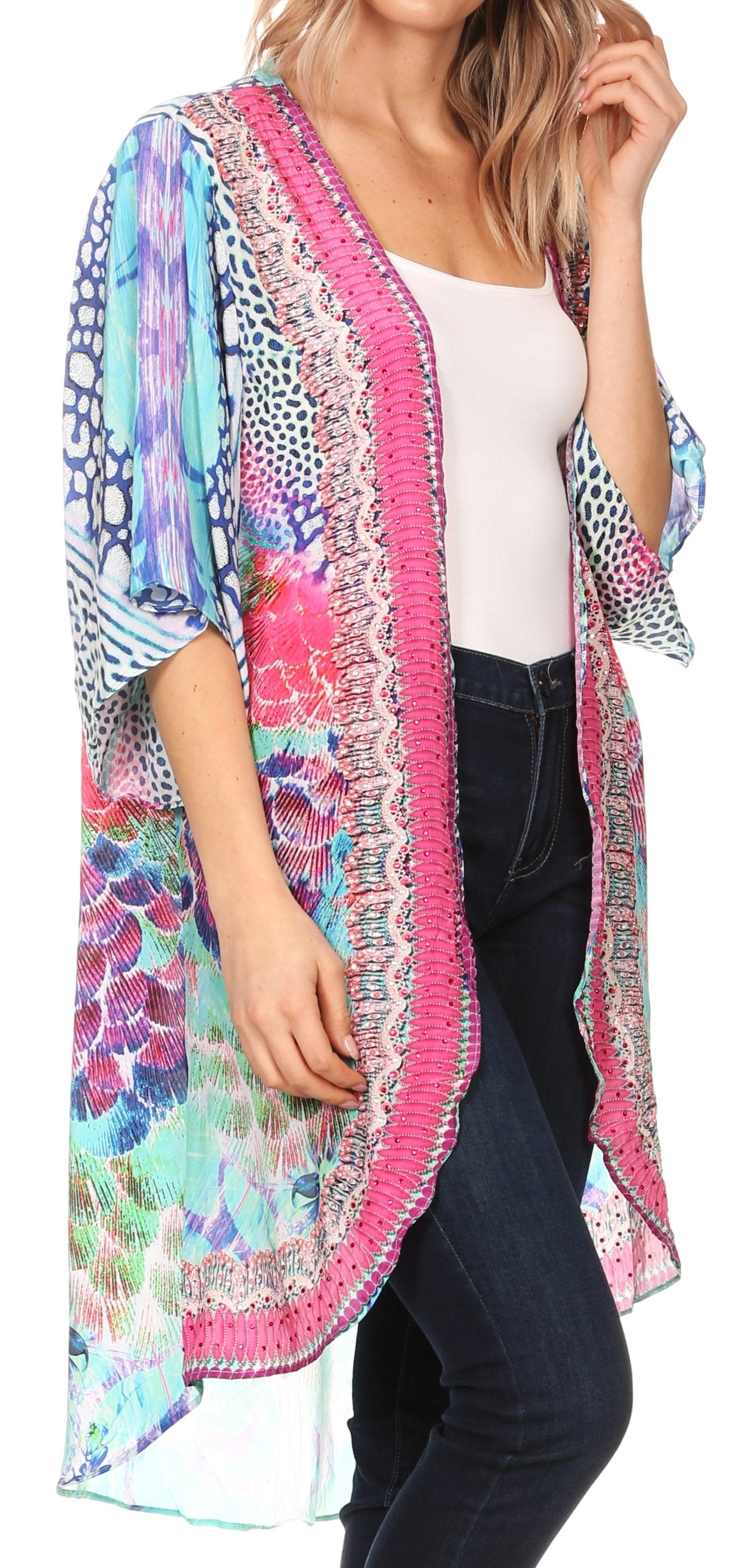 Woman wearing a colorful patterned kimono-style jacket on a white background