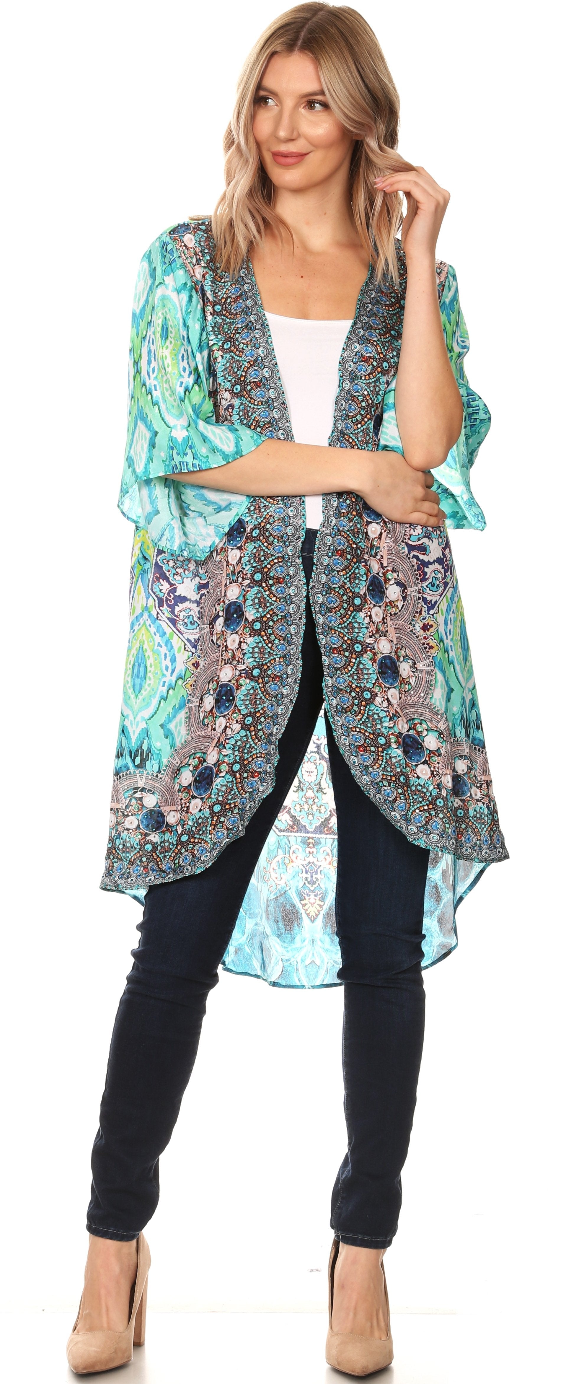 Woman wearing a colorful kimono-style jacket over a white top and black pants.