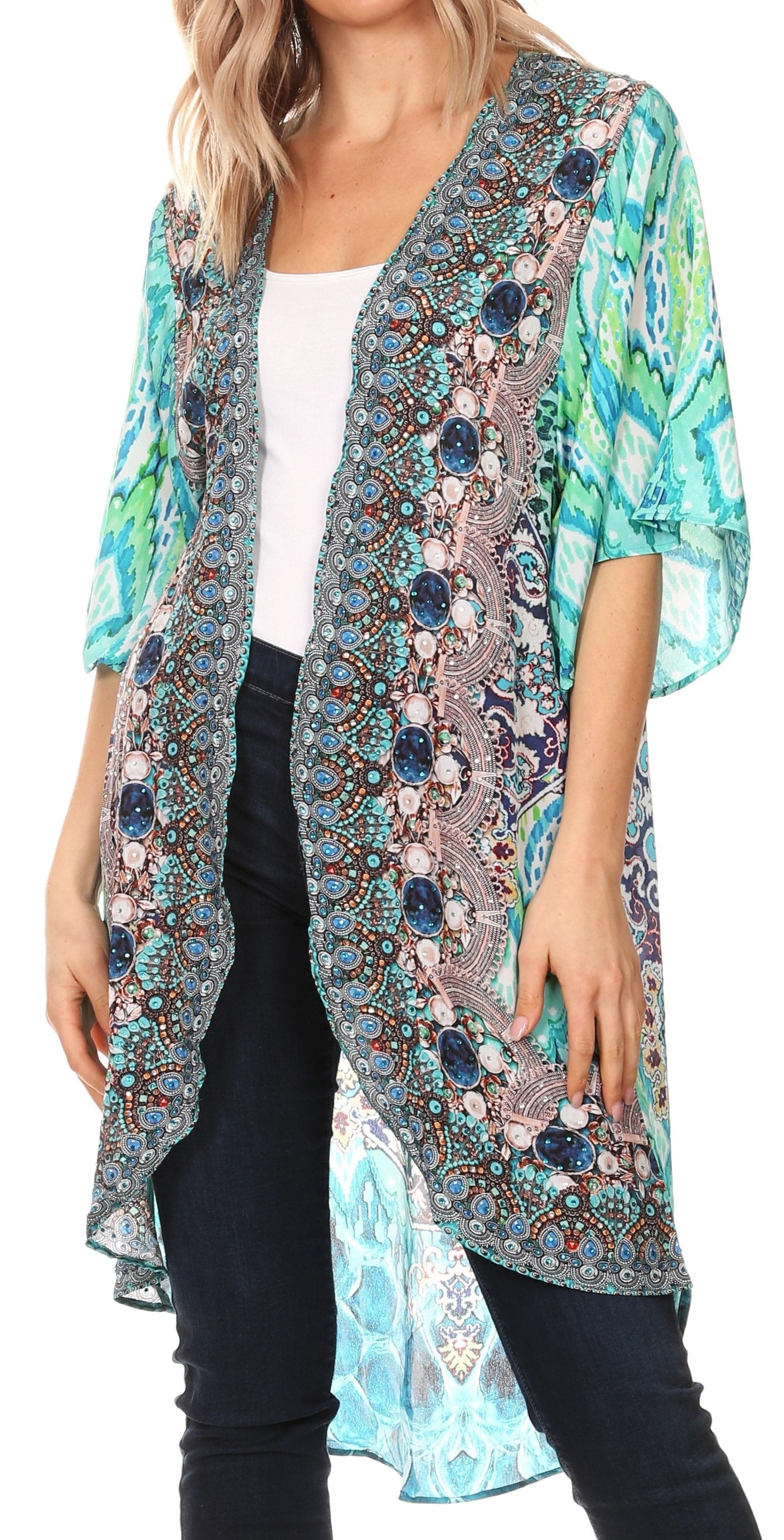 Woman wearing a colorful floral kimono-style jacket over a white top and black pants.