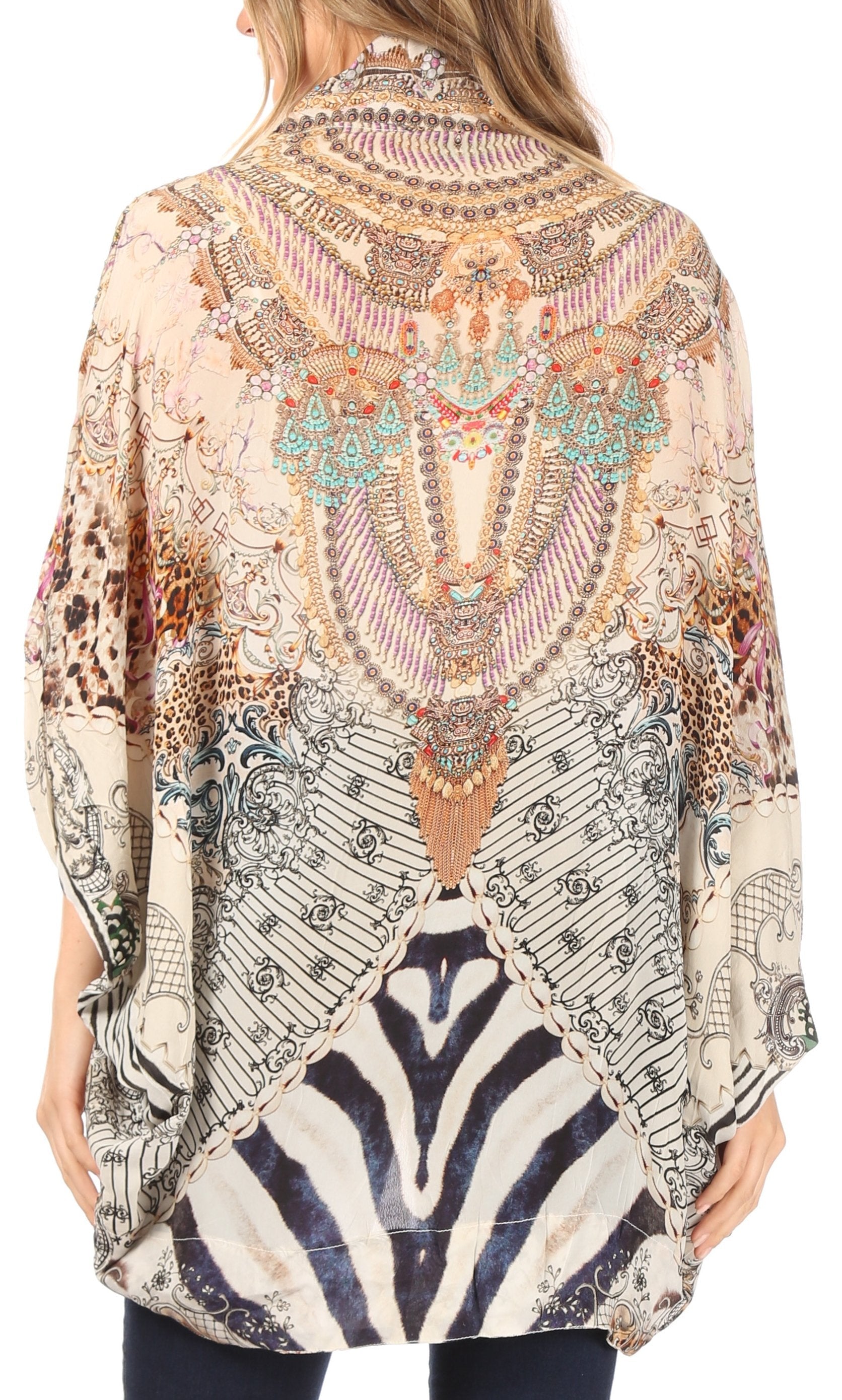 Woman wearing a patterned blouse with a mix of abstract and animal print designs.