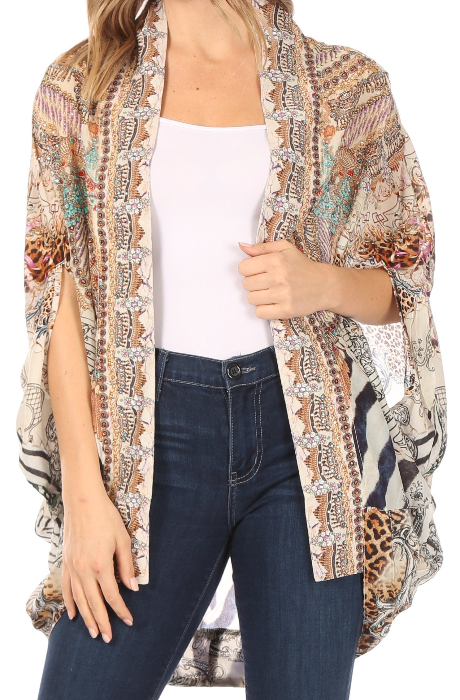 Woman wearing a patterned kimono over a white top and blue jeans on a white background