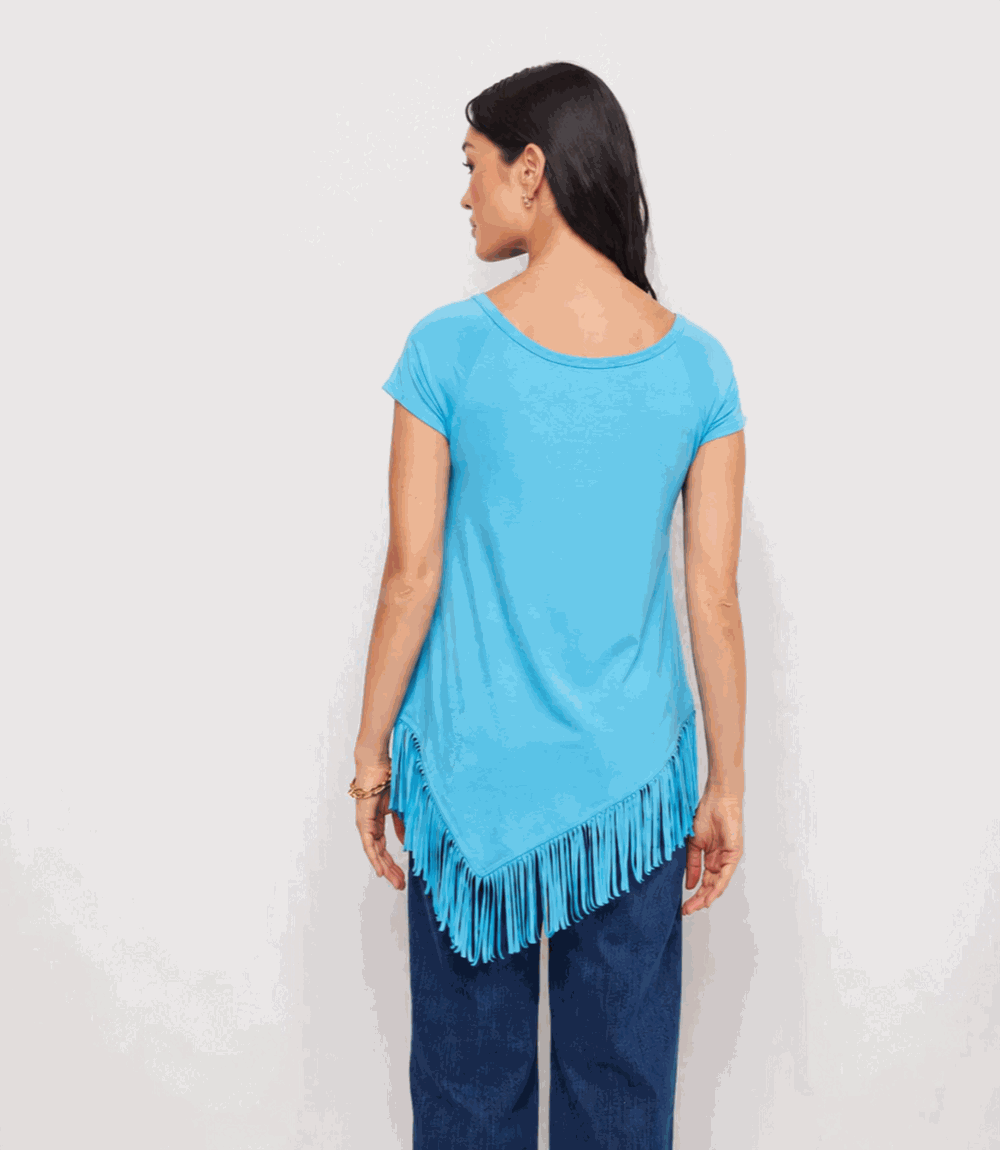 Woman wearing a blue fringe top against a white background